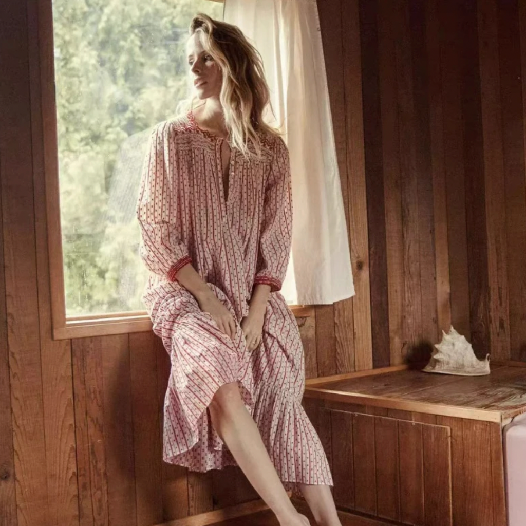 Introducing the Nightgown Heloise: a long-sleeved, stripe-patterned dress for women with delicate red embroidery and a stylish half-open collar. Stay comfortable and timeless with a touch of elegance. Perfect for any occasion.