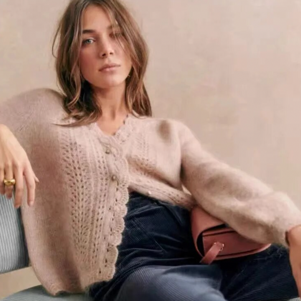 Introducing the Cardigan Angelie, a delicate wool blend cardigan perfect for spring and summer. Designed with gentle crochet knitted details, this cardigan offers both style and comfort. Stay fashionable and cool with this must-have addition to your wardrobe.