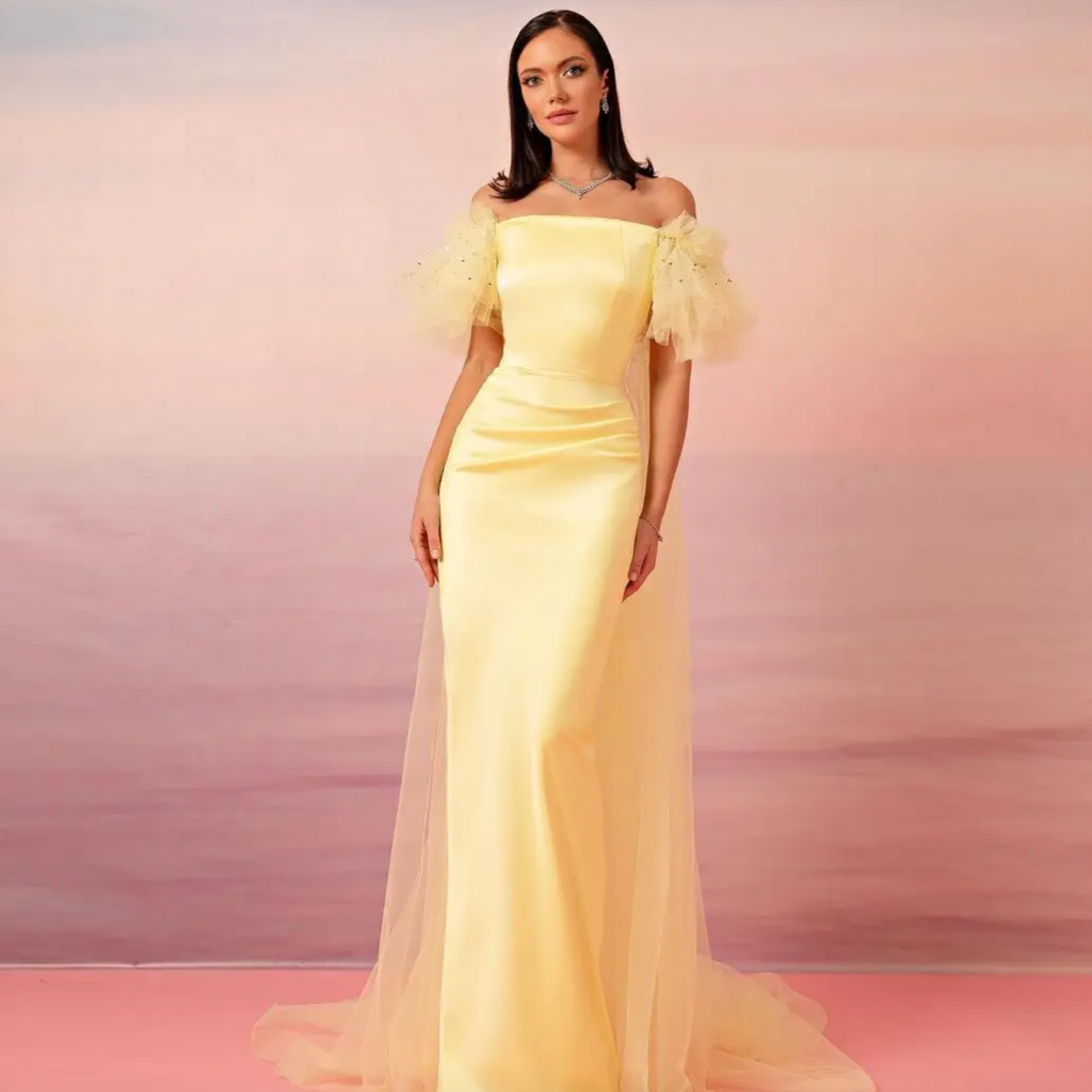 Turn heads with this exquisite Robe Maceline dress, featuring cream yellow tones, an off-shoulder neckline, and sequins beading. The romantic cape and backless design completes an elegant look. The perfect choice for a special event, this formal dress showcases simple beauty and premium style.