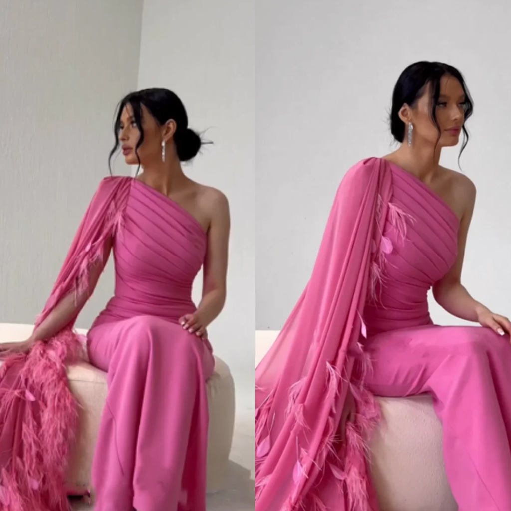 Dress Valencia is a stunning addition to any formal event. Its elegant one shoulder design and mermaid silhouette is accented by feather details and ruched cap sleeves. Perfect for a prom or evening occasion, this dress exudes sophistication and grace.
