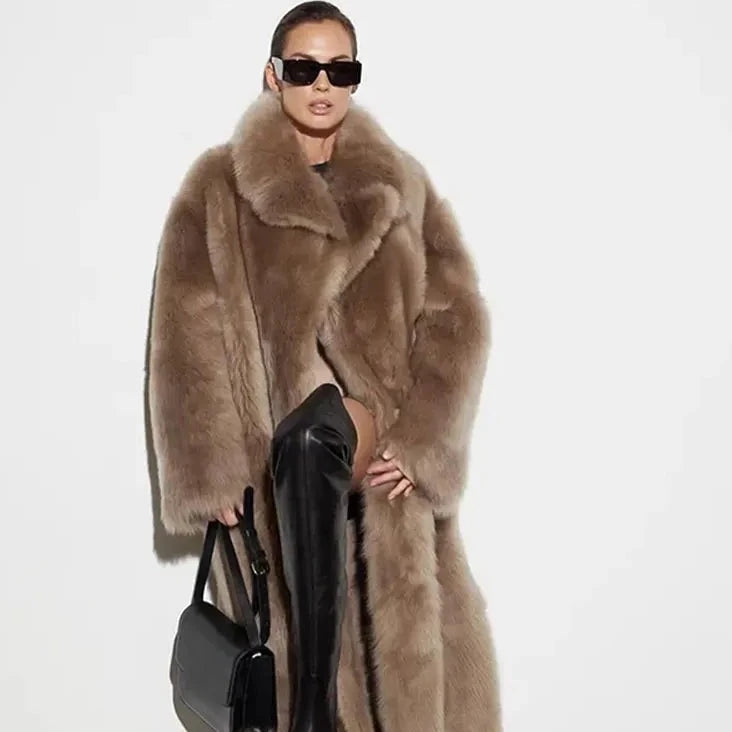 Stay warm and stylish this winter with our Female Winter Coat. With a thick, faux fur fabric and a loose fit, you'll feel cozy while making a fashion statement. The polo collar and long sleeves add a touch of sophistication, making it a versatile piece for any occasion. Go ahead, stay warm and fashionable all season long!