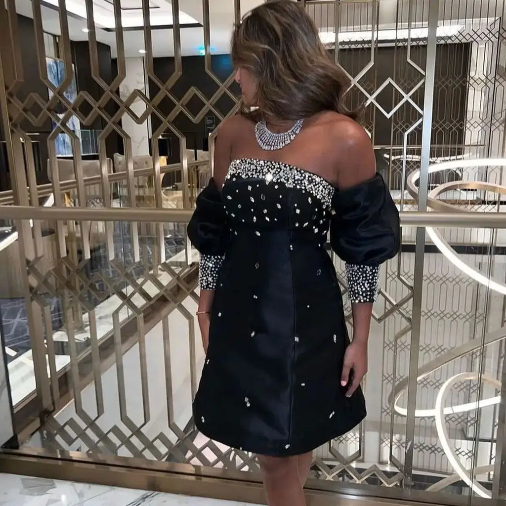 Indulge in opulence with Dress Astoria. Adorned with dazzling beads, this strapless evening dress exudes luxury. The half sleeves and knee-length hem add a touch of sophistication to this cocktail dress, perfect for a night of elegance and glamour. Elevate your style with Dress Astoria.
