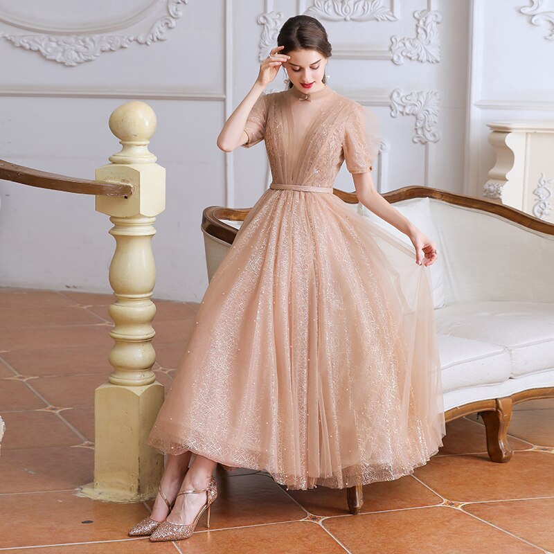 This stunning tea length dress, the Robe Tiffany, will make you feel like royalty. With its sparkling design, it exudes a princess-like elegance that is sure to turn heads. Perfect for any formal event, this dress is both stylish and sophisticated. Channel your inner princess with the Robe Tiffany.