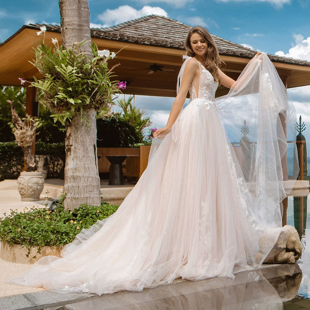Look like a true goddess on your special day with the Robe Daymara. This breathtaking gown features a lightweight A-line silhouette adorned with sparkling jewels and intricate embroidery. Experience timeless elegance and make a statement with this beautiful bridal design.