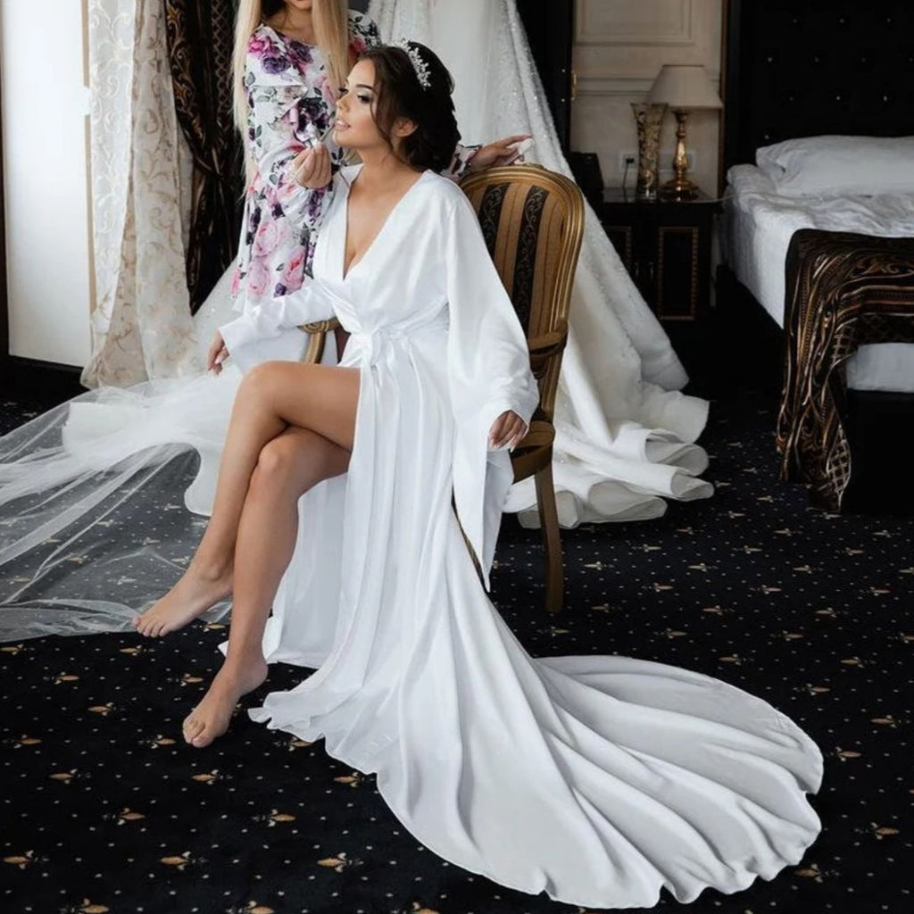 Dare to be a risk-taker in this stunning white silk wedding robe. Marce is long and luxurious, with long sleeves, giving you a bold and beautiful look for your special day. Celebrate in style and make sure all eyes are on you!