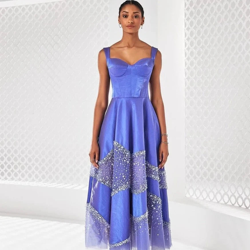 Elevate your evening with Dress Emaline. Exuding elegance and vintage charm, this dress features a sweet and sexy silhouette adorned with shimmering purple beading and intricate sequins. Embrace the formal occasion with a touch of luxury and sophistication.