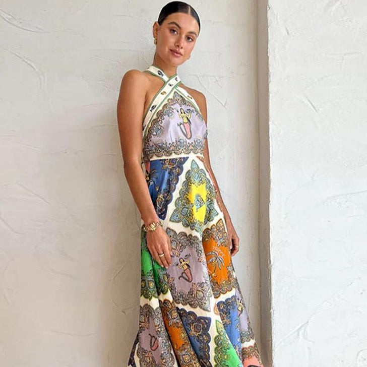 Indulge in the luxurious and ethically-made Robe Ausha. This Trippy Troppo Printed Linen Halter Midi Dress exudes nostalgia and island-bound femininity. With eyelet embroidery, cascading ruffles, open back, and matching swimwear, it's the timeless and sophisticated vacation wardrobe you've been dreaming of.