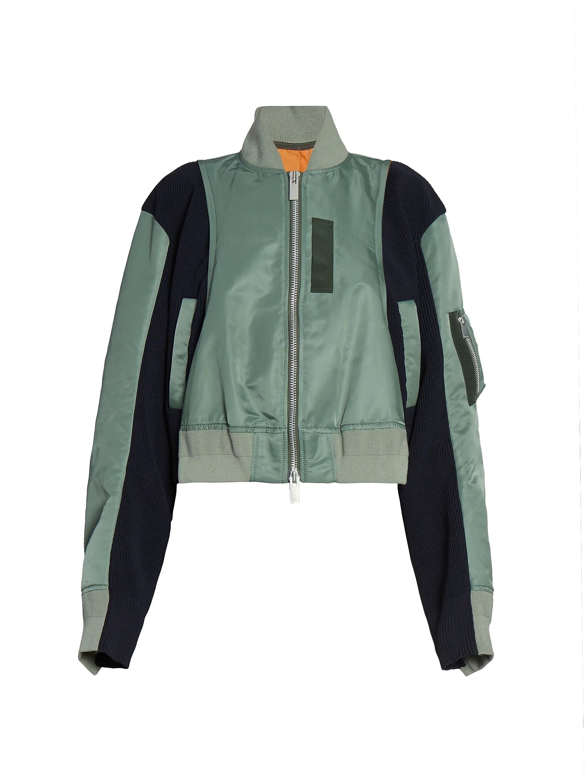 This Nylon Twill Knit Bomber Jacket from Sacai features inset ribbed panels that create a unique striped texture, enhancing its modern cropped blouson silhouette. Designed with a ribbed stand collar and snap cuffs, it combines style with comfort. Practical chest, side, and sleeve zip pockets offer secure storage, while the back vent ensures ease of movement. A two-way front zip closure completes this versatile piece, perfect for elevating your wardrobe with a distinctive, fashion-forward edge.