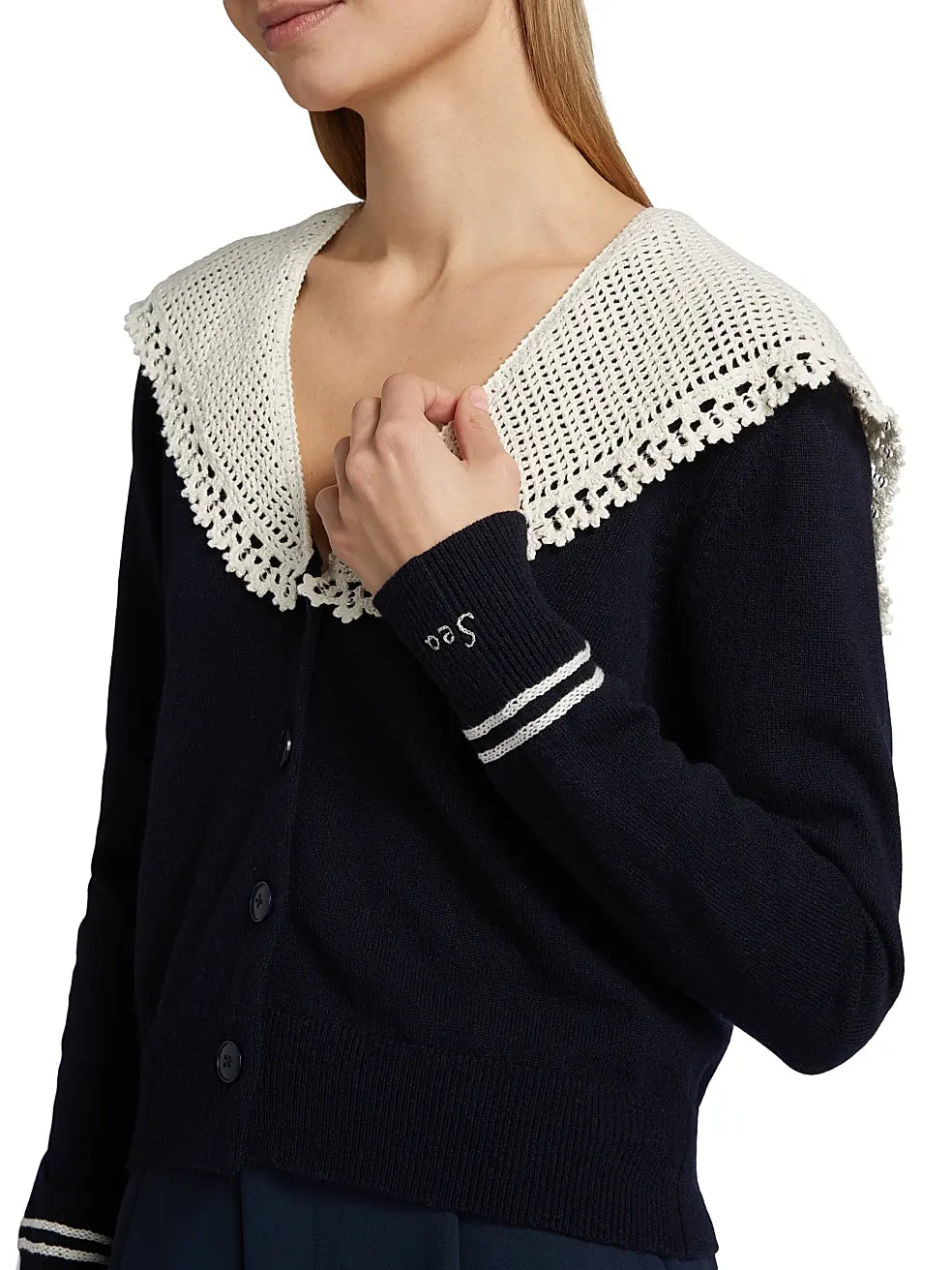 Elevate your everyday wardrobe with the Marie Embroidered Wool Knit Cardigan from Sea. Crafted from luxurious wool, this sophisticated piece features an elegant spread collar and intricate embroidery detailing that adds a touch of refined artistry. The long sleeves and button-front closure offer effortless styling versatility, making it perfect for layering over dresses or pairing with your favorite basics. A timeless investment piece that combines comfort with understated elegance.