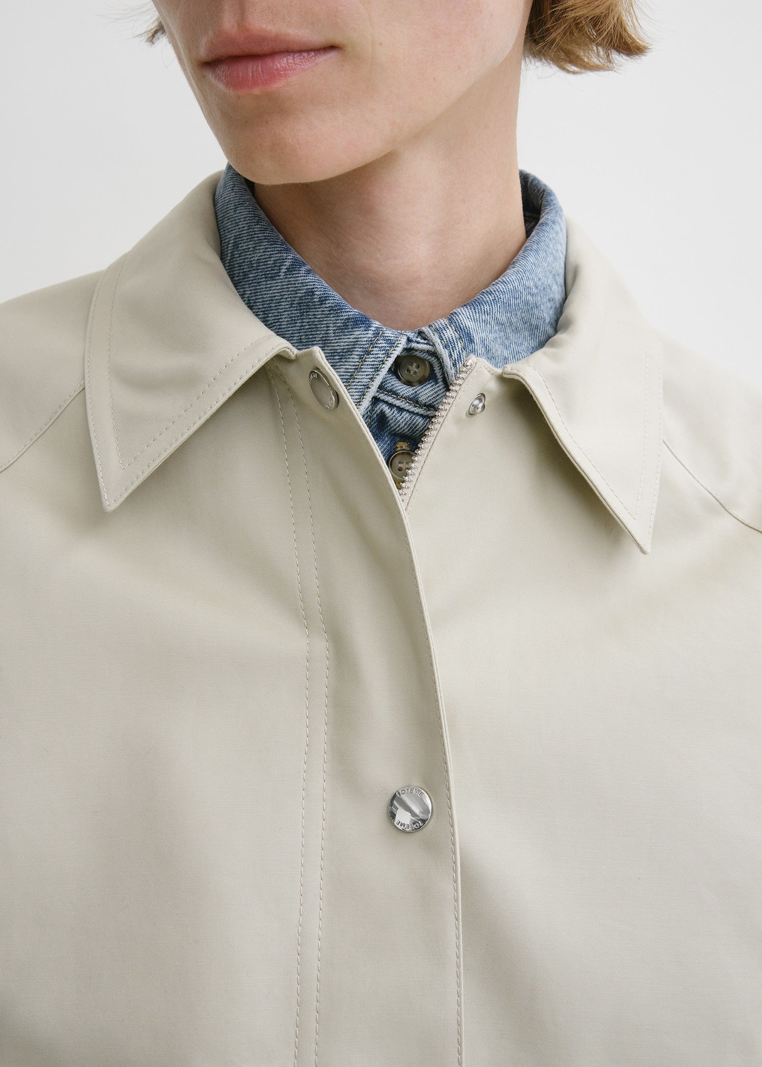 This cropped cotton jacket by Toteme in a warm sand hue features a wide, boxy silhouette with roomy raglan sleeves for a modern, relaxed fit. Crafted from compact organic cotton, it offers durability and comfort. Functional details like a silver-tone zipper, snap buttons, and utilitarian flap pockets add practicality without compromising style. Fully lined in a matching tone, it pairs effortlessly with jeans and pumps, making it the perfect choice for casual coffee outings with a chic edge.