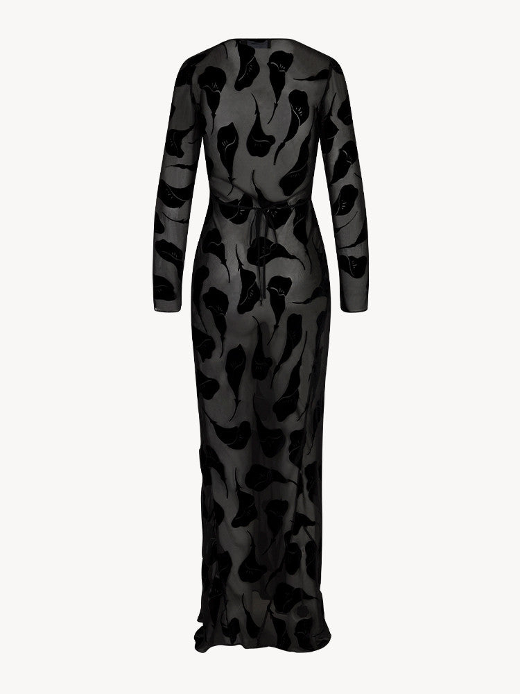 The Inka Dress in Falling Lily Devore combines elegance and subtle allure with its long, semi-sheer design that offers just the right amount of coverage. Featuring a deep neckline and a bias-cut skirt, it captures the ethereal grace of Kate Bush and the bohemian spirit of Joni Mitchell. Ideal for cooler summer nights, this dress pairs beautifully with sky-high heels to create a look of effortless, sexy femininity.