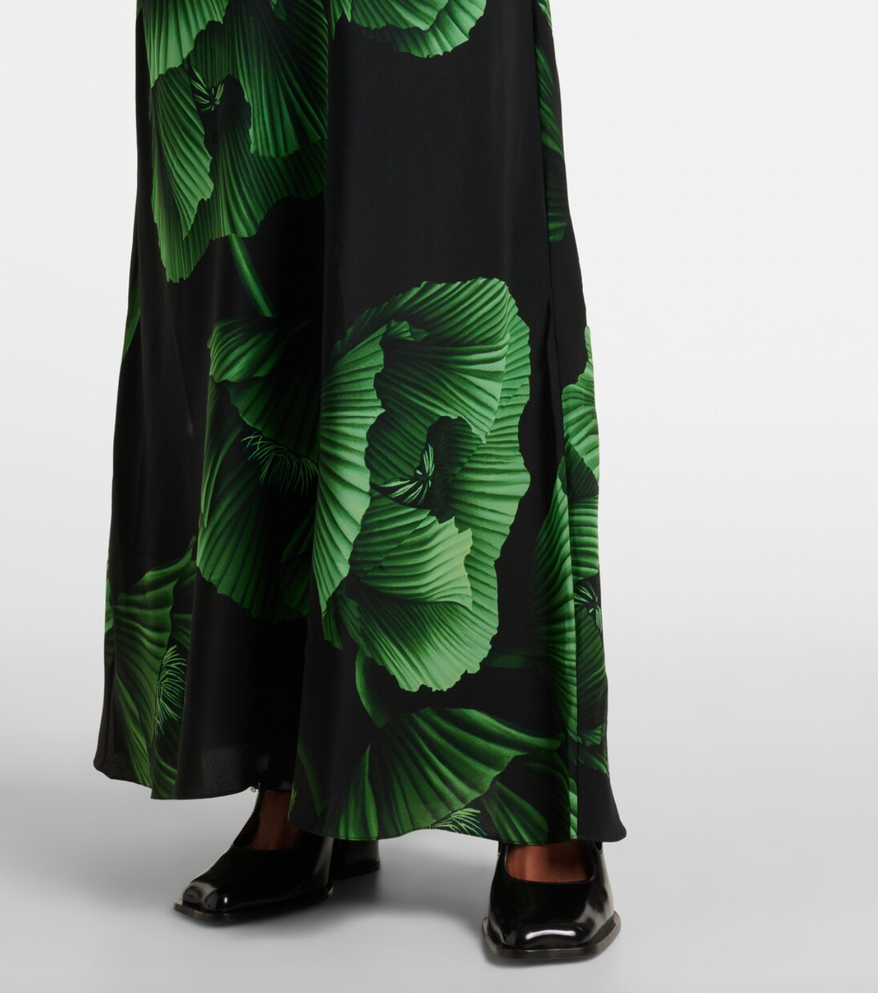 Experience elegance with the Floral Embroidered Silk Gown in green by Johanna Ortiz. Crafted from fluid silk, this floor-grazing gown showcases delicate floral embroidery and is enhanced by a dramatic draped cape detail. Perfect for making a graceful statement, it combines luxurious comfort with timeless sophistication.