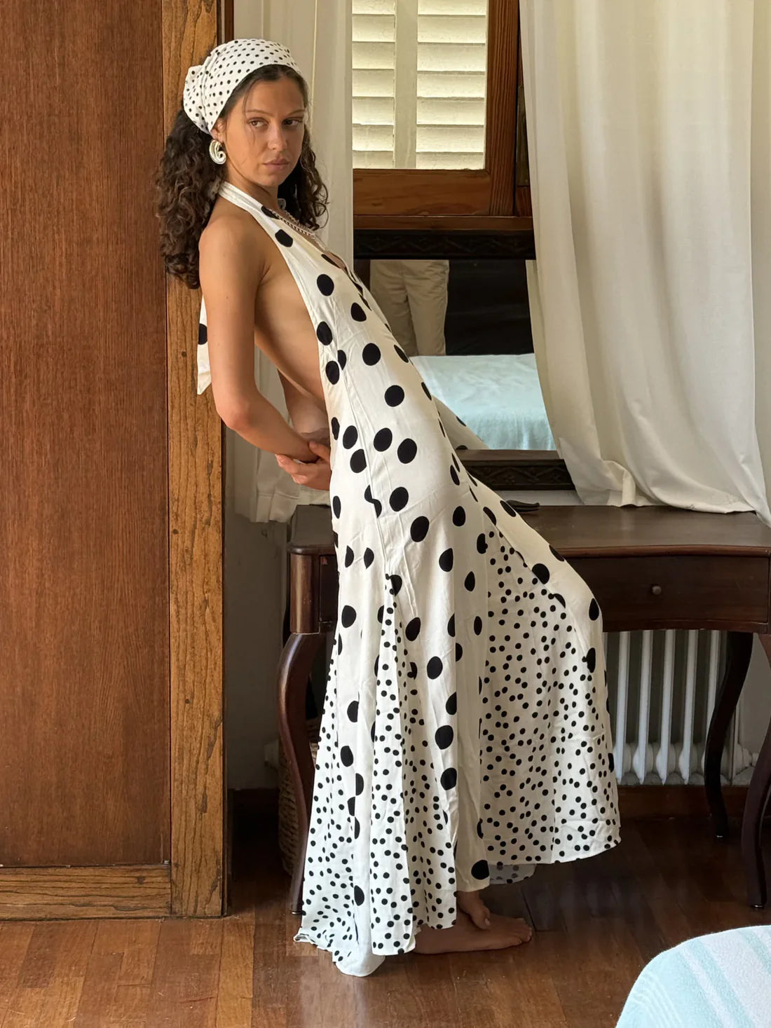 Embrace summer elegance with the Maria Dress, a sleeveless halter maxi featuring a playful dot print and lace-up back for a stunning, backless look. Perfect for vacations or warm evenings, its flowing fabric ensures comfort and style while turning heads wherever you go. Make every moment memorable in this effortlessly graceful dress.