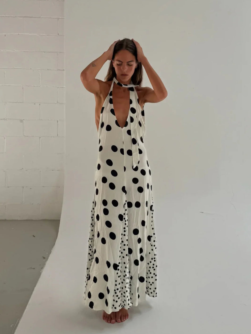 Embrace summer elegance with the Maria Dress, a sleeveless halter maxi featuring a playful dot print and lace-up back for a stunning, backless look. Perfect for vacations or warm evenings, its flowing fabric ensures comfort and style while turning heads wherever you go. Make every moment memorable in this effortlessly graceful dress.