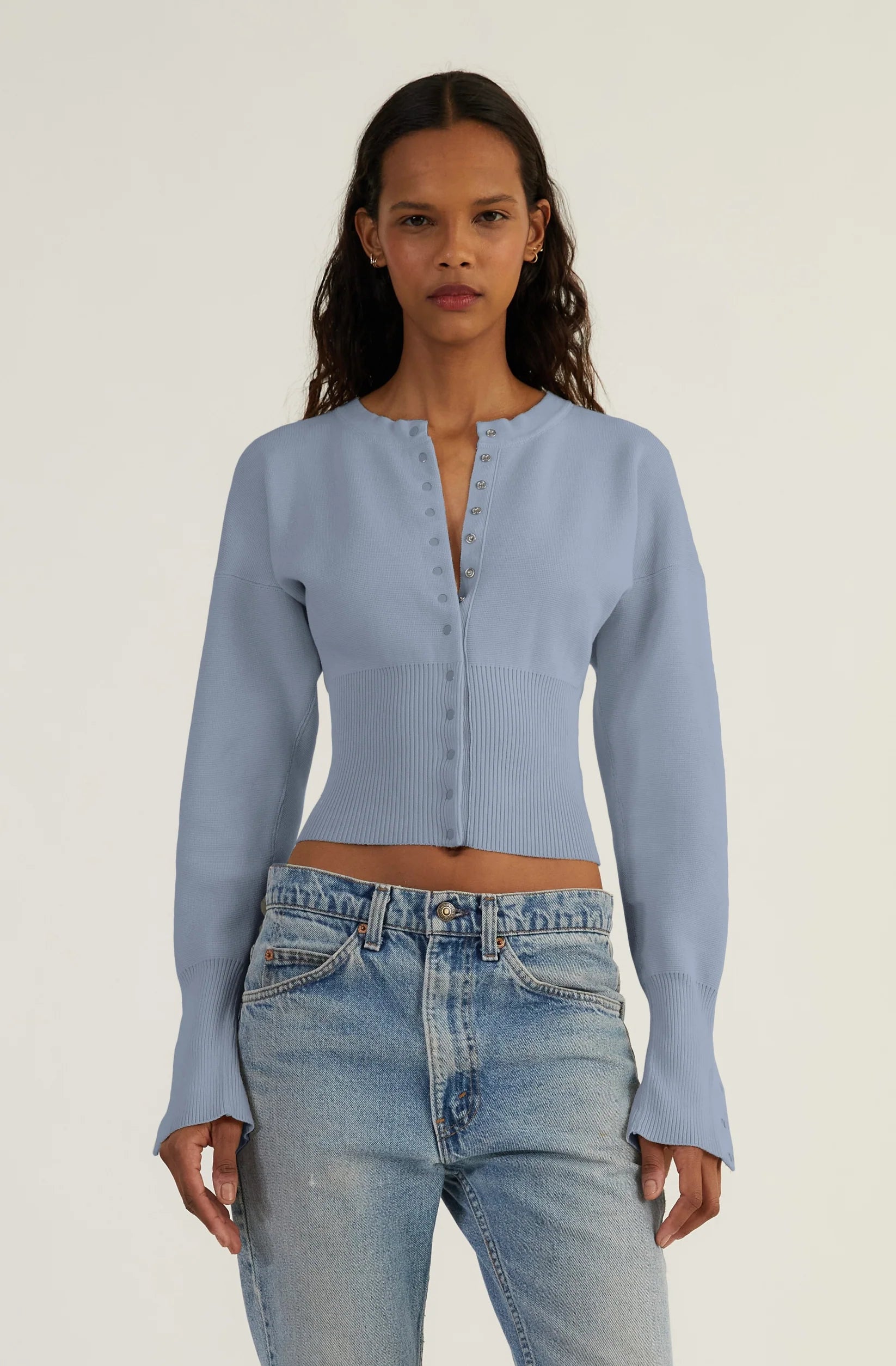 Elevate your style with The Weekend Knit Cardigan by Orseund Iris. Made from a luxurious blend of cotton and silk, this chunky Milano knit cardigan adds volume at the shoulders and cinches at the waist for a flattering silhouette. With its long and dramatic sleeves, it's the perfect addition to your wardrobe for a touch of sophisticated elegance.