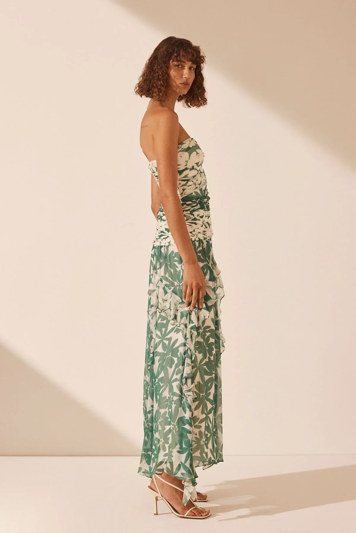 Unleash your inner flower child with the Marguerite Dress by Shona Joy! This stunning ruched maxi dress features a detachable strapless neckline and spliced contrast print, highlighting the exclusive Marguerite print. The lightweight semi-sheer chiffon adds a touch of elegance, while the boning in the bodice and invisible back zip provide a flattering fit. Perfect for any occasion, the gathered frill maxi length skirt will make you feel like a goddess.