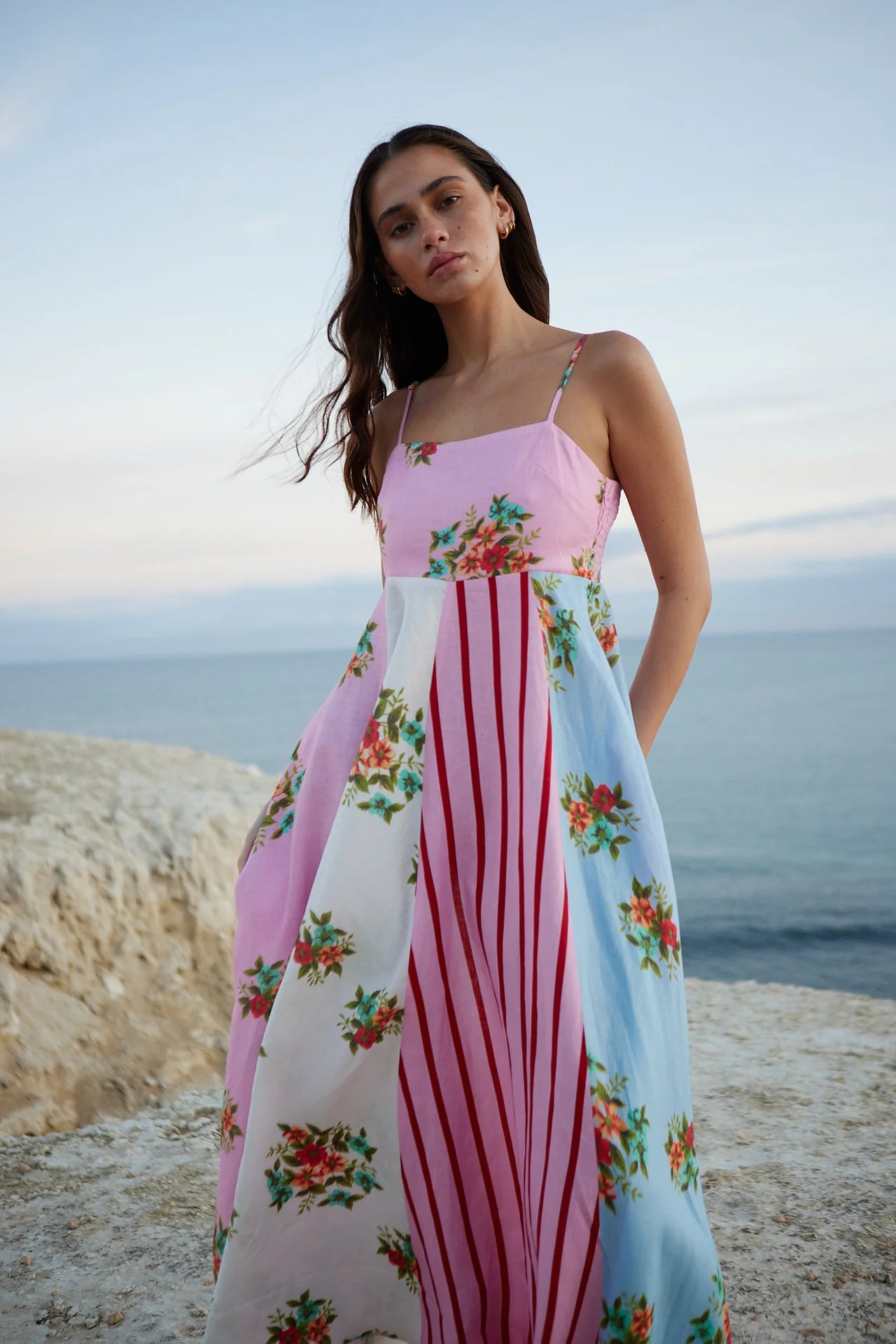 Introducing the Rue Dress - a vibrant patchwork maxi dress that blends soft florals and striking stripes for a unique and joyful look. The light, airy fabric and delicate spaghetti straps make it perfect for summer adventures, while the playful yet sophisticated mix of prints adds elegance to any occasion. Make a statement with effortless style.