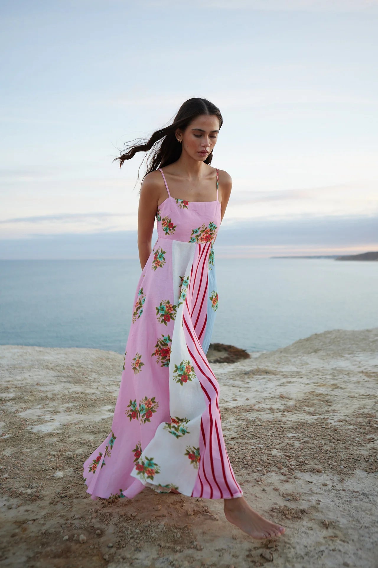 Introducing the Rue Dress - a vibrant patchwork maxi dress that blends soft florals and striking stripes for a unique and joyful look. The light, airy fabric and delicate spaghetti straps make it perfect for summer adventures, while the playful yet sophisticated mix of prints adds elegance to any occasion. Make a statement with effortless style.