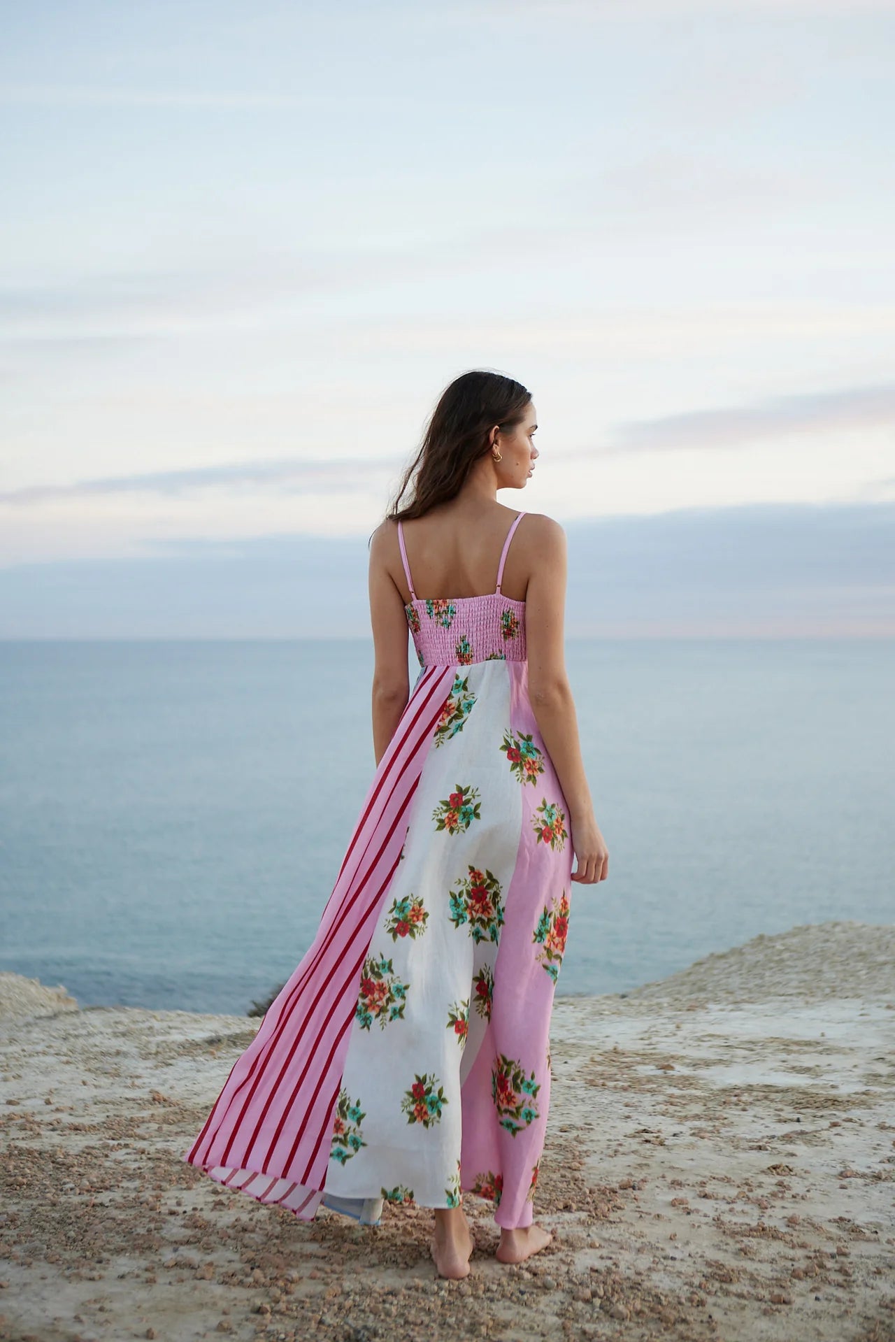 Introducing the Rue Dress - a vibrant patchwork maxi dress that blends soft florals and striking stripes for a unique and joyful look. The light, airy fabric and delicate spaghetti straps make it perfect for summer adventures, while the playful yet sophisticated mix of prints adds elegance to any occasion. Make a statement with effortless style.