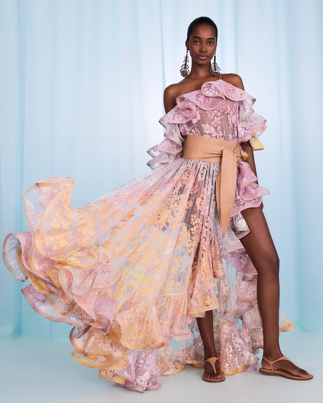 Step into the spotlight with the Dawning Ruffled Midi Dress in Lace from Zimmermann’s Spring 2025 Illumination Collection. This playful piece dazzles with asymmetric ruffles, a cape-style back, and a captivating side split flaunting a bold print. Perfect for turning heads at evening events, it pairs effortlessly with sleek heels and a chic clutch for a look that’s both dramatic and delightfully fun.