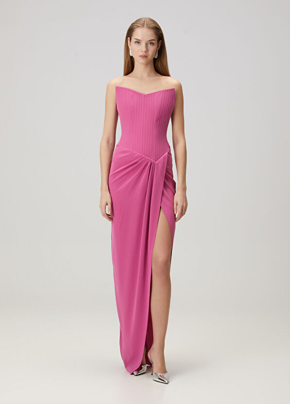 Elevate your evening look with this stunning pink maxi dress by Alex Perry that combines timeless elegance with modern sophistication. The strapless design creates a graceful silhouette, while expertly placed drapes add dimension and movement to every step. A daring thigh-high slit offers a hint of allure without compromising the dress's refined aesthetic. The secure back zipper ensures a flawless fit that lasts all night. 