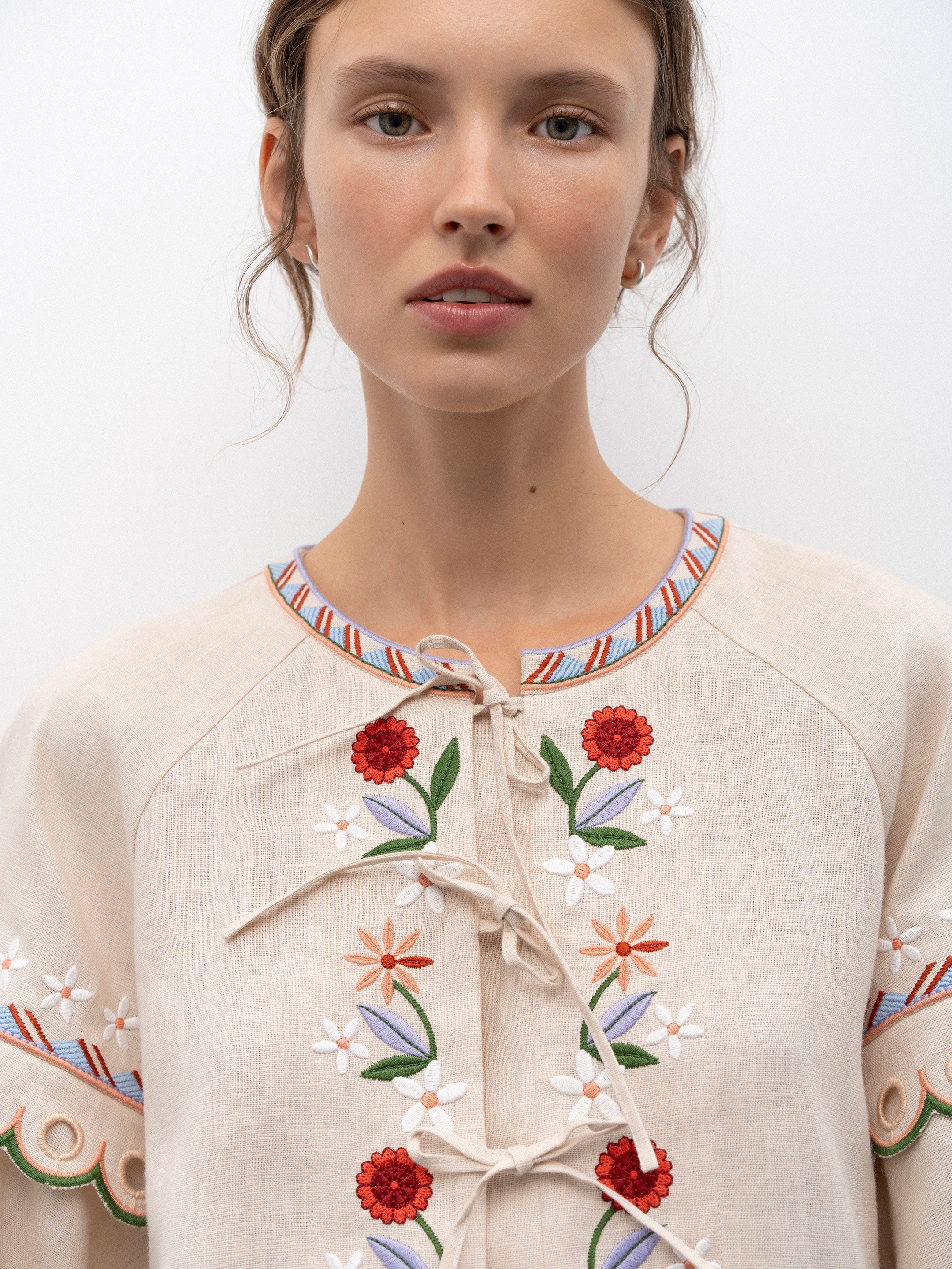Get ready to turn heads with the Leena Embroidered Blouse! This stylish blouse features a beautiful 3D flower embroidery, flared sleeves, and a chic lace-up neckline. Embrace your unique fashion sense with this vintage-inspired piece.