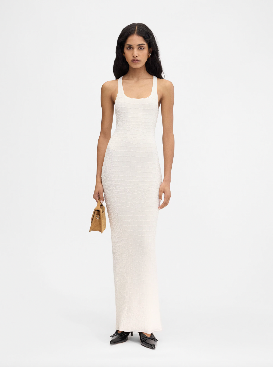 The Scala dress by Jacquemus combines elegance and edge with its long, fitted silhouette crafted from crocodile-embossed stretch viscose. Its square neckline and sleeveless racerback design enhance your natural shape while offering comfort and style. A long back slit adds a daring touch, and the subtle “J” locker loop detail sets this dress apart. Perfect for making a bold statement at any event.