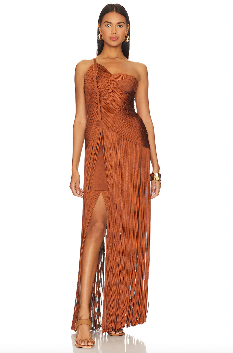 Elevate your style with Hervé Léger's Draped Fringe One Shoulder Gown. The stunning swingy fringe and draped cross-over bodice exude elegance and sophistication, making it perfect for exclusive events. With an asymmetric one-shoulder neck and layered skirt, indulge in luxurious fashion.
