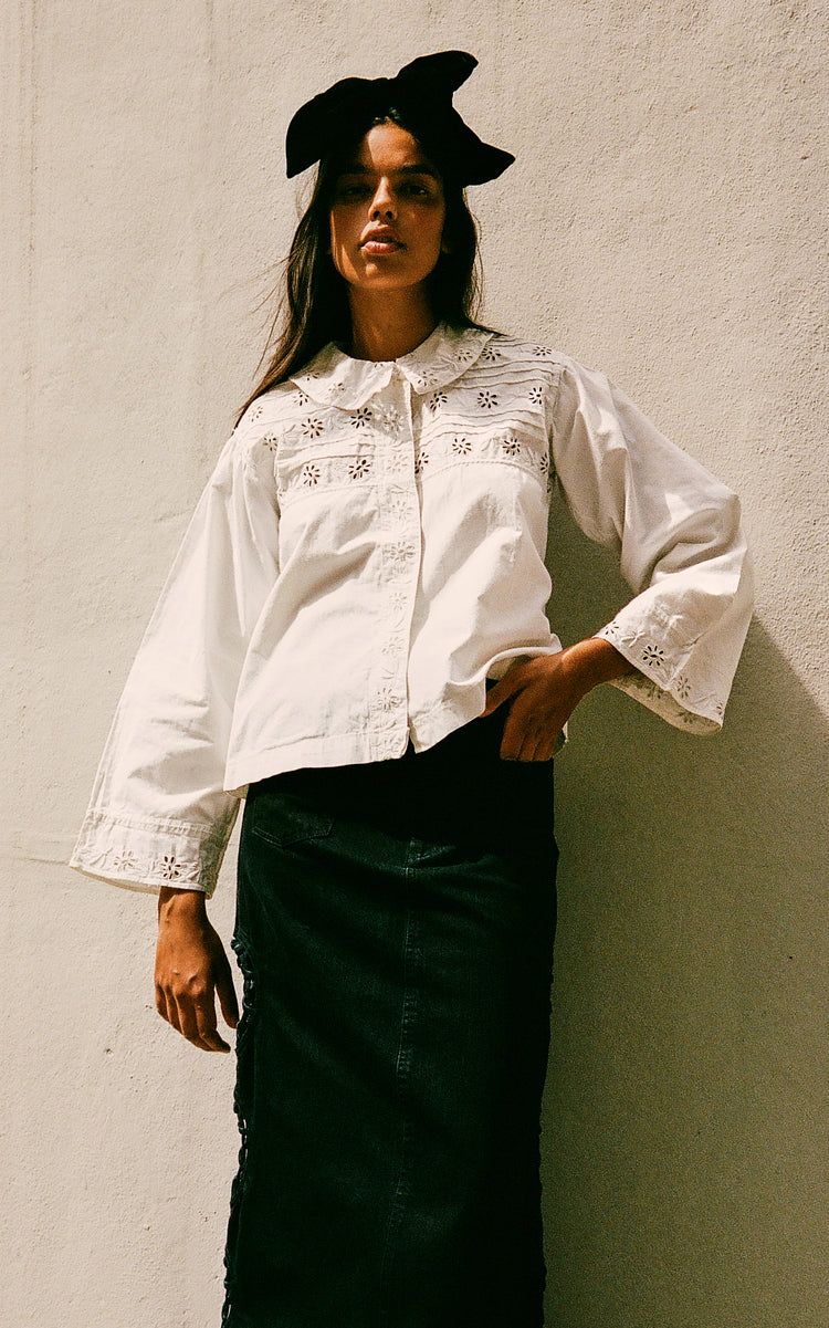 Get ready to rock the fashion world with the Paloma Eyelet Top! This collared top features a relaxed fit and is made with 100% cotton for ultimate comfort. Unlined for a breezy feel, it comes in a classic white color and has a button and zip fastening. Perfect for a casual yet chic look!