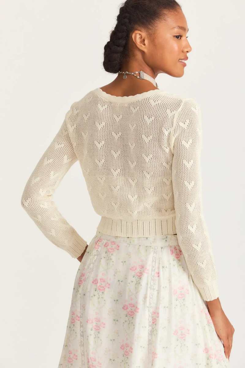 Upgrade your wardrobe with Cardigan Venice. This elegant knitted sweater comes in a vintage design with intricate embroidering and a chic cropped style. The long sleeves will keep you warm, while the unique hollow out details add a touch of sophistication. Perfect for adding a luxurious touch to any outfit.