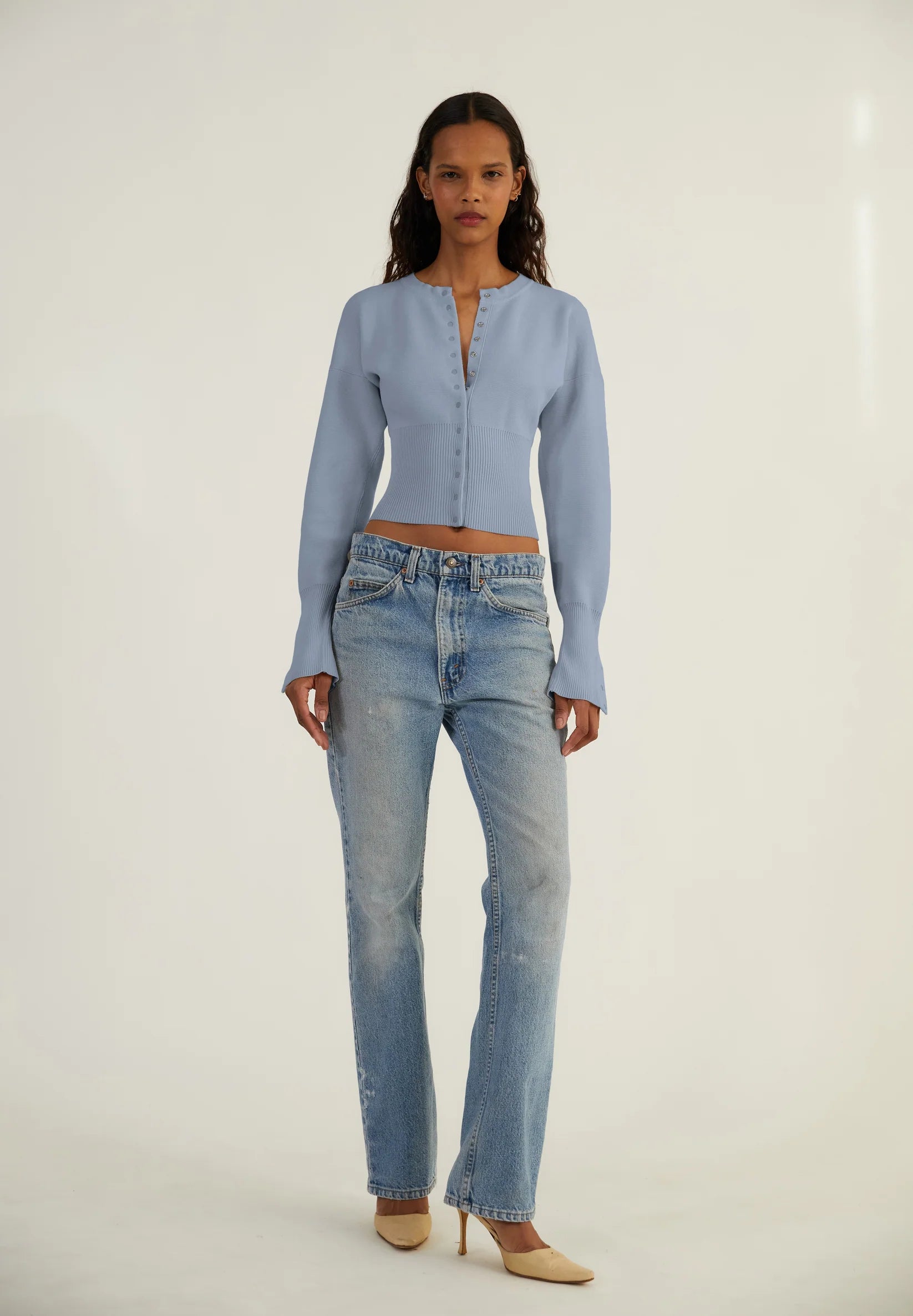 Elevate your style with The Weekend Knit Cardigan by Orseund Iris. Made from a luxurious blend of cotton and silk, this chunky Milano knit cardigan adds volume at the shoulders and cinches at the waist for a flattering silhouette. With its long and dramatic sleeves, it's the perfect addition to your wardrobe for a touch of sophisticated elegance.