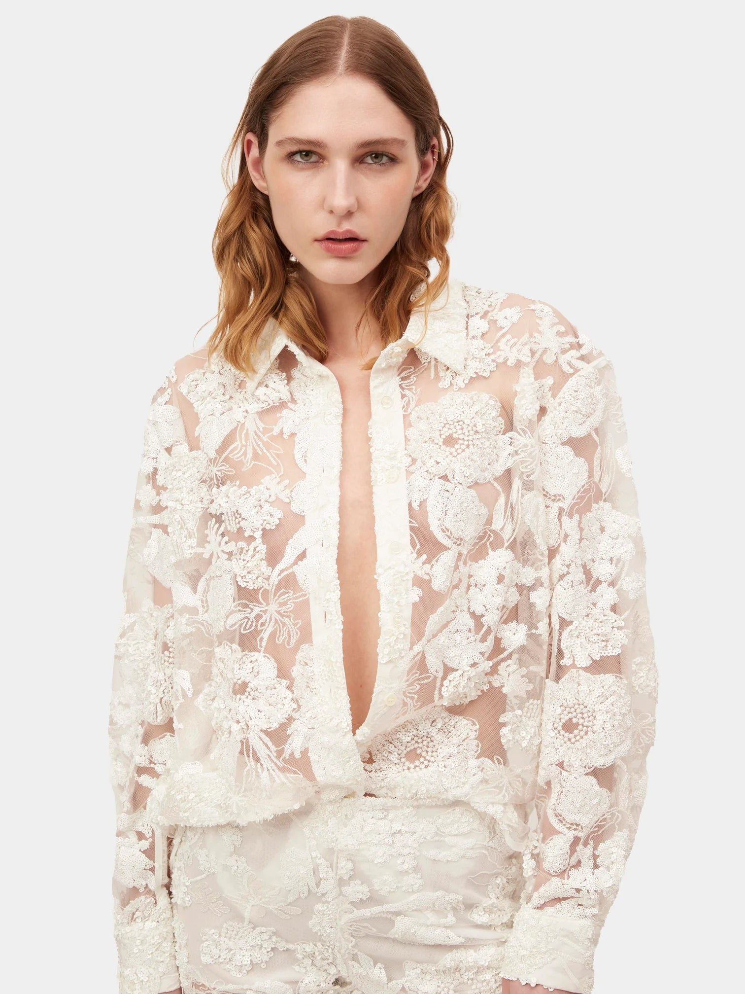 Introducing the Cara Set, a button-up style shirt crafted from exquisite sequin embroidered tulle, designed exclusively by AKNVAS. Elevate your wardrobe with this luxurious piece that combines sophistication and artistry. Perfect for any occasion, this shirt exudes style and exclusivity.