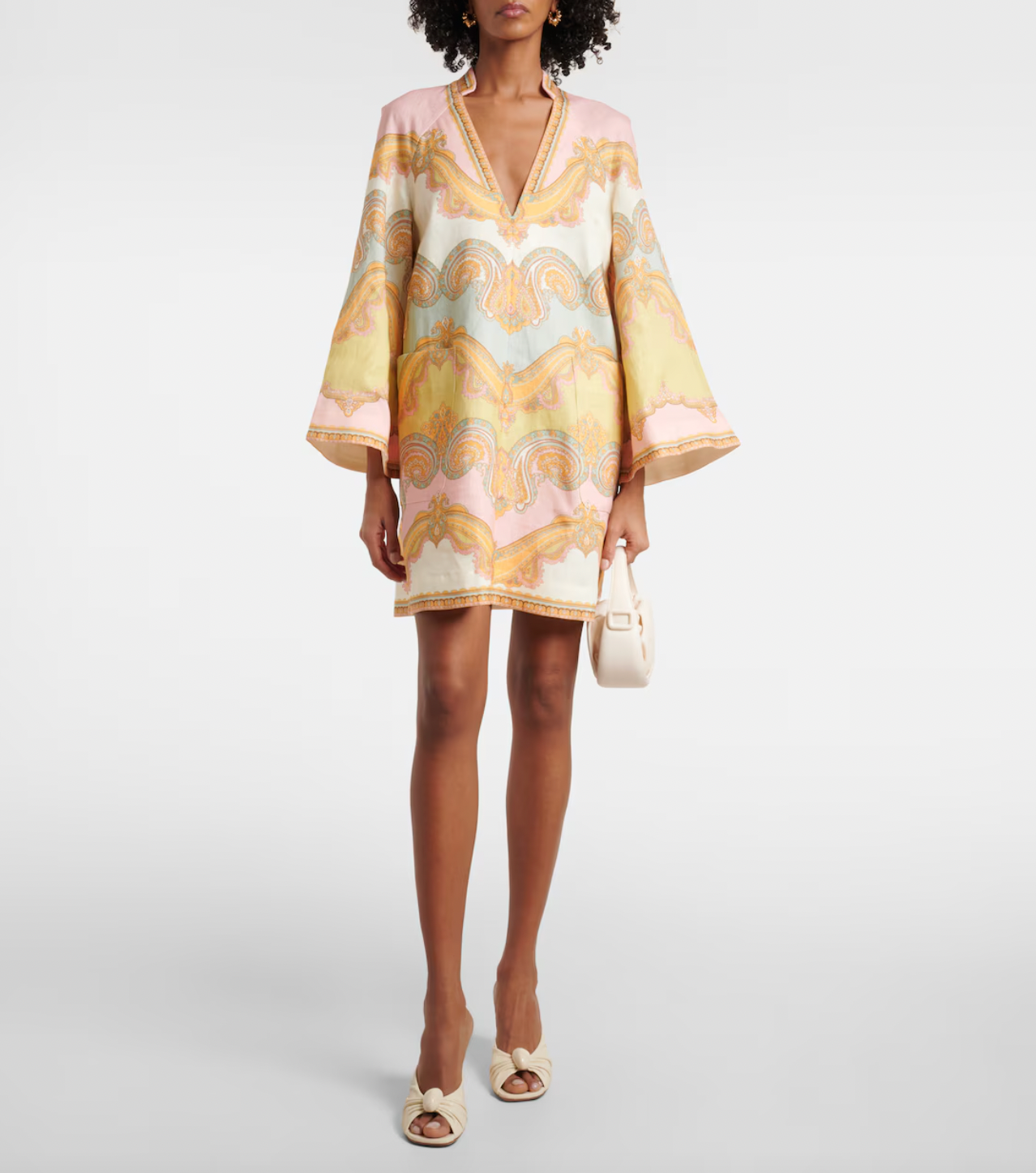 Elevate your resort style with the Maxine paisley linen minidress in Gold Paisley by Zimmermann. Made from breathable linen, this dress combines comfort with elegance, featuring a deep V-neckline and wide sleeves that enhance its chic appeal. Practical patch pockets add convenience, while the center back zip provides a tailored fit. Perfect for relaxed daytime outings or sophisticated evening events, this dress is a versatile addition to your wardrobe.