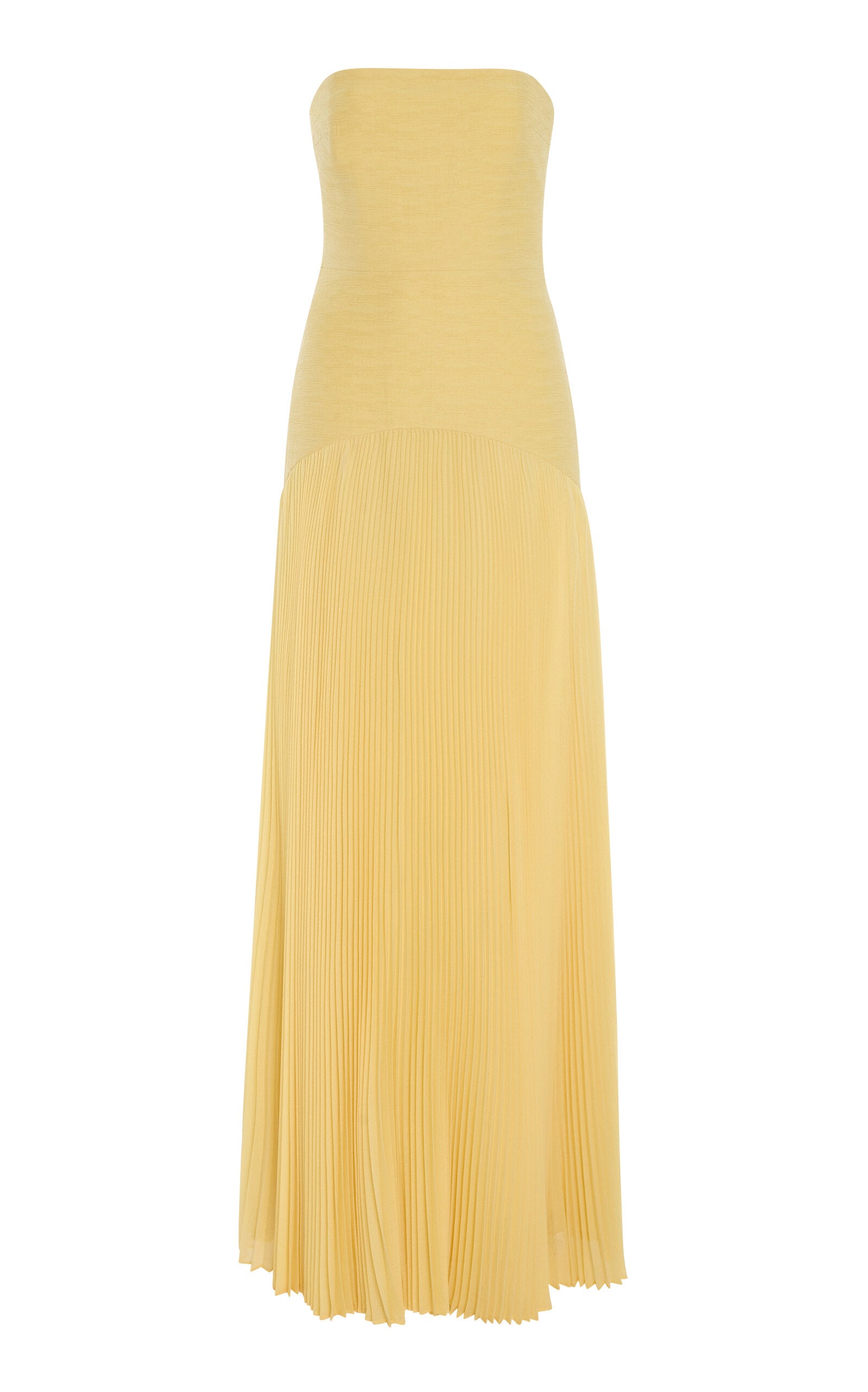 The Sunniva Dress showcases a fitted strapless bodice with a graceful curved dropped waist, seamlessly flowing into a delicate plisse skirt. Its elegant silhouette highlights your figure while offering effortless movement. Pair it with bold statement earrings to complete a look that embodies refined sophistication and modern style. Perfect for making a lasting impression at any event.