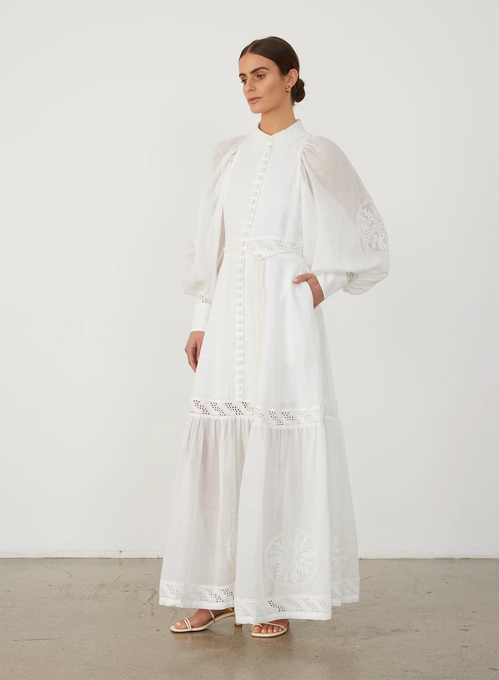 Indulge in timeless elegance with Theodora Maxi Dress by Joslin. Crafted from European Flax Linen, this dress features a classic collar and a shirt fit at the bodice, falling into a full skirt. The stunning ramie organdy sleeves and hem panel add an ethereal touch. Adorned with intricate cotton doilys and crochet buttons for a sophisticated finish.