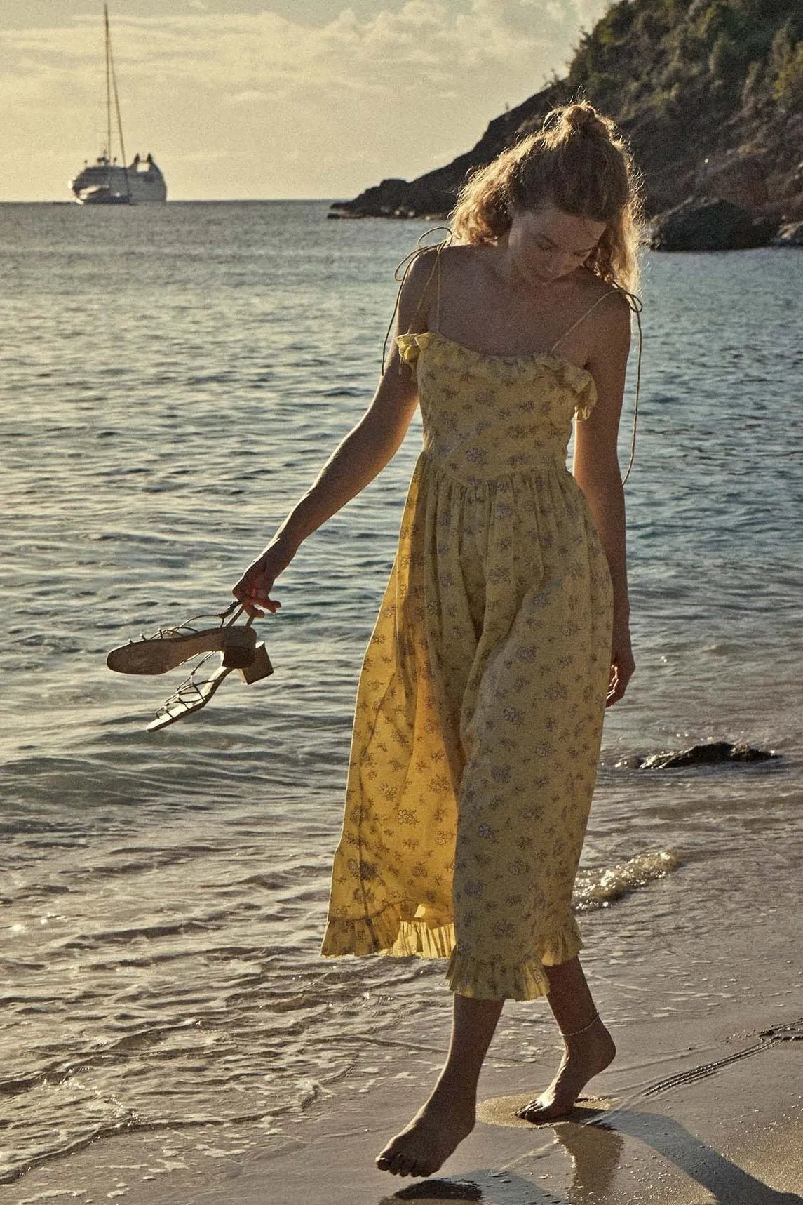 Indulge in the elegance of the Wendelin Midi Dress by Dôen. This beautiful cotton dress features a charming yellow, brown, and cream floral pattern, along with a flattering v waist and adjustable straps for a perfect fit. The delicate ruffle adds a playful touch to this sophisticated and exclusive sundress.