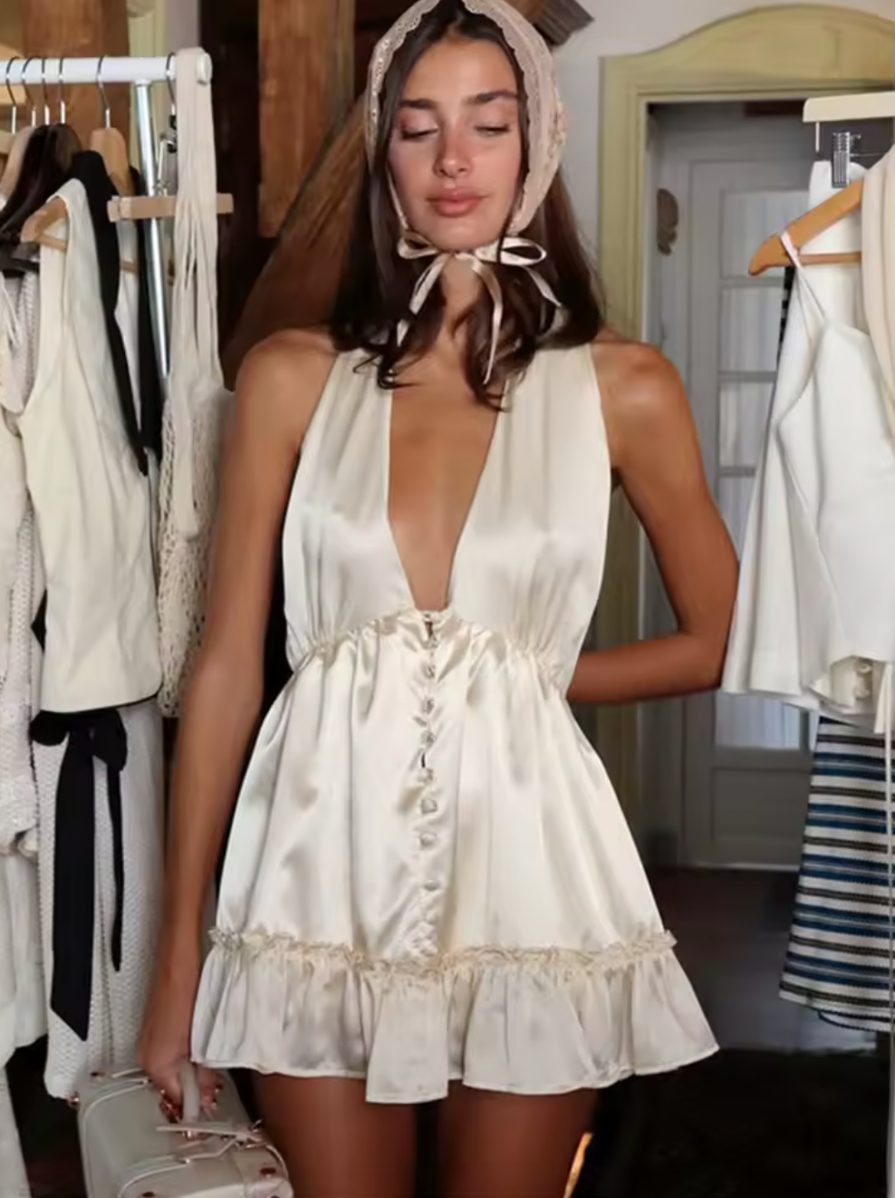 Experience elegance with the Caroline Silk Dress by Fait par Foutch. Made from medium-weight 100% silk charmeuse, this dress offers a smooth, luxurious feel and graceful drape. Fully lined with pure silk, it ensures all-day comfort. Functional silk-covered buttons adorn the front, while the adjustable halter straps tie into a bow for a perfect fit. The low V-neck and back, combined with hidden elastic at the waist, create a flattering silhouette that moves with you. 