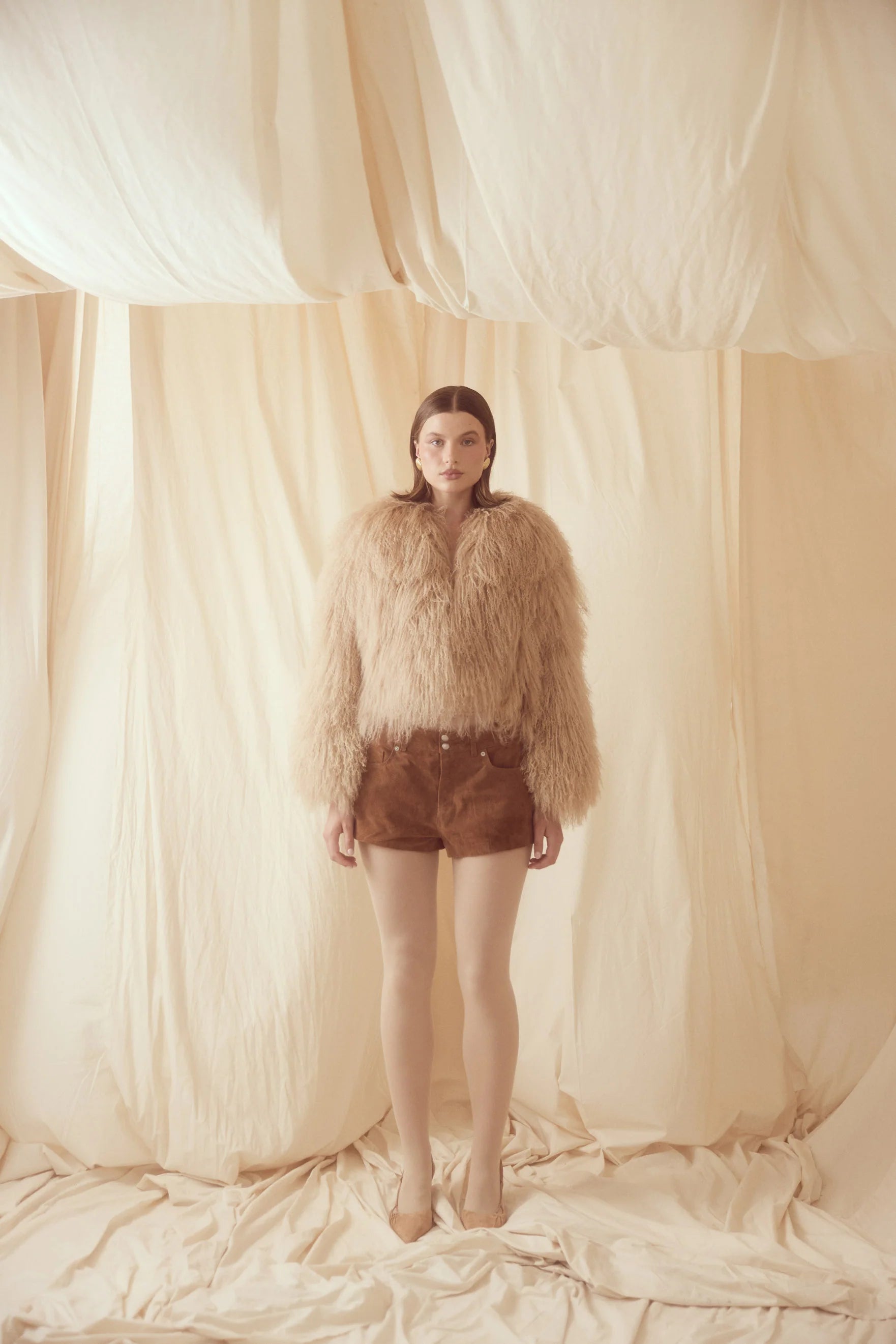 The Georgina Jacket combines timeless style with bold attitude, crafted from 100% luxurious Mongolian lamb fur. Its sleek design features concealed fastenings for a clean, sophisticated look. Perfect for making a statement, this jacket offers both elegance and warmth for any occasion.