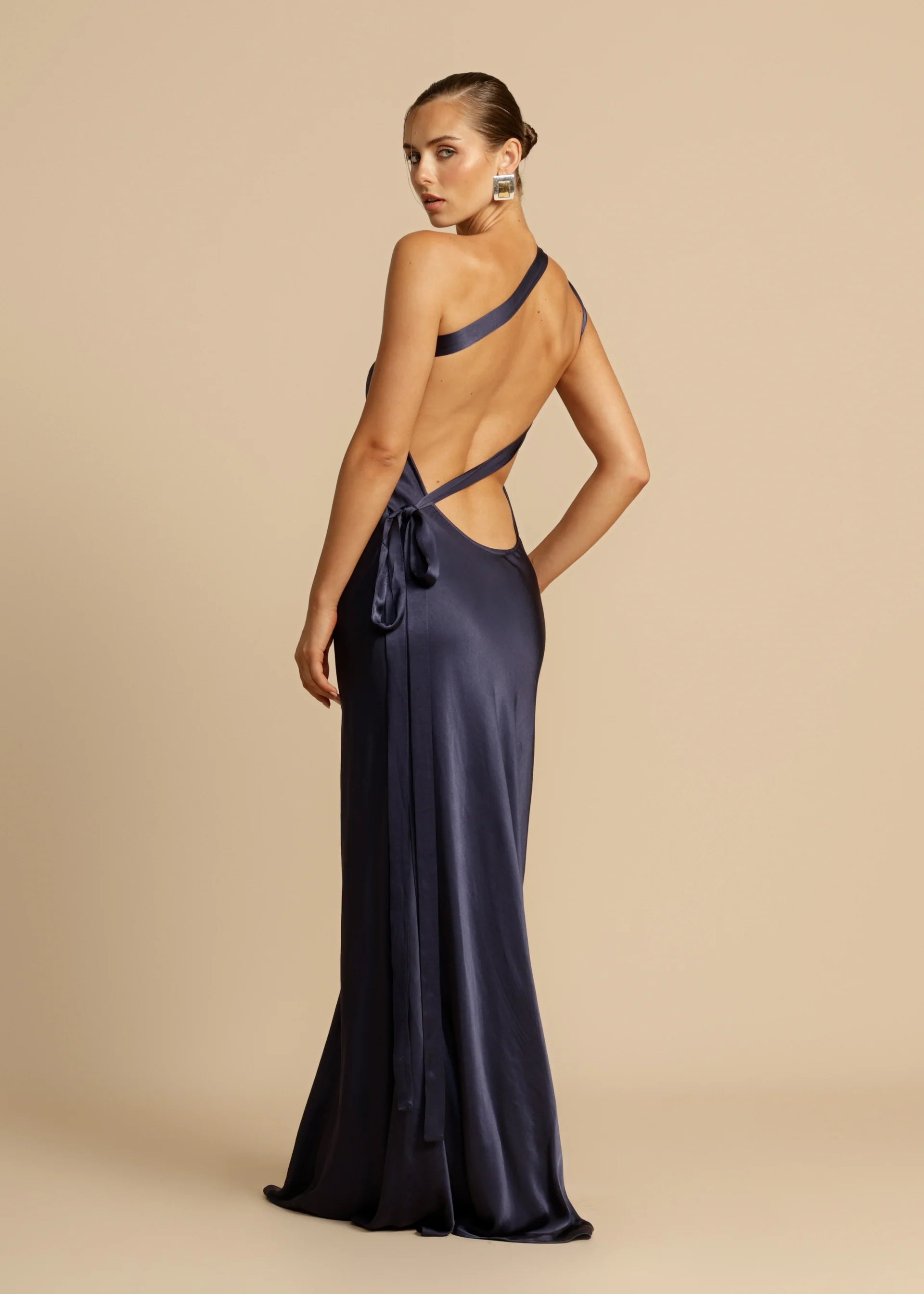 Unleash your inner diva with Monique, a stunning floor-length gown that exudes modern elegance. Crafted from luxurious viscose to enhance your curves, Monique's one-shoulder design, open back, and crossover detailing exude sophistication. Whether it's a starlit night or a glamorous event, Monique is the perfect choice for making a lasting impression.
