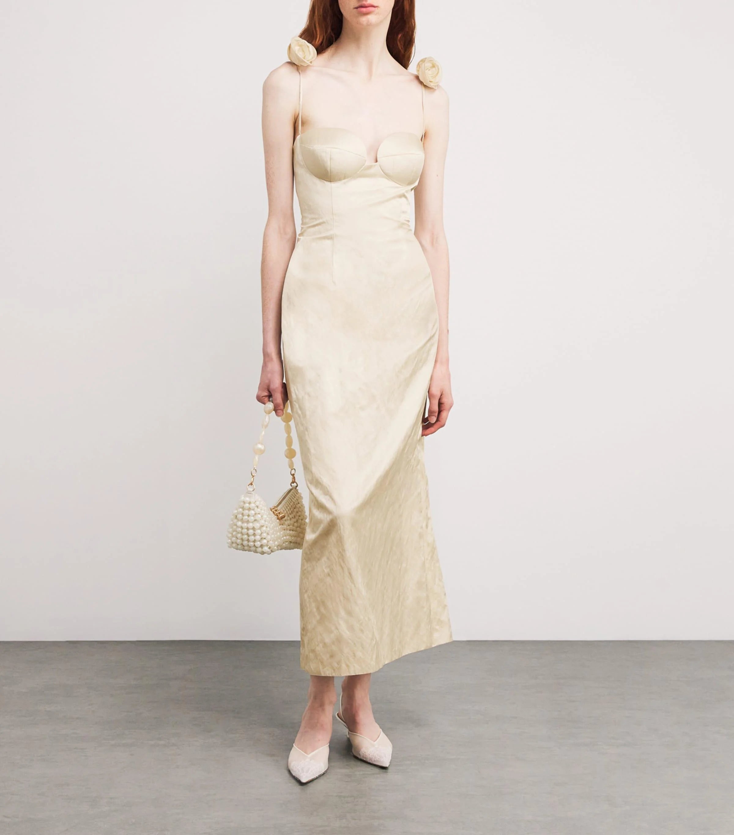 This Rosette bustier midi dress in cream redefines elegance with its iconic shape crafted from luxurious Japanese cotton crinkle fabric. The delicate 3D rosettes on the shoulder straps add a refined, romantic touch, making it perfect for standout occasions. Its flattering bustier silhouette enhances your figure while the breathable fabric ensures comfort throughout the day or night. Elevate your wardrobe with this timeless piece that blends classic design with contemporary details.