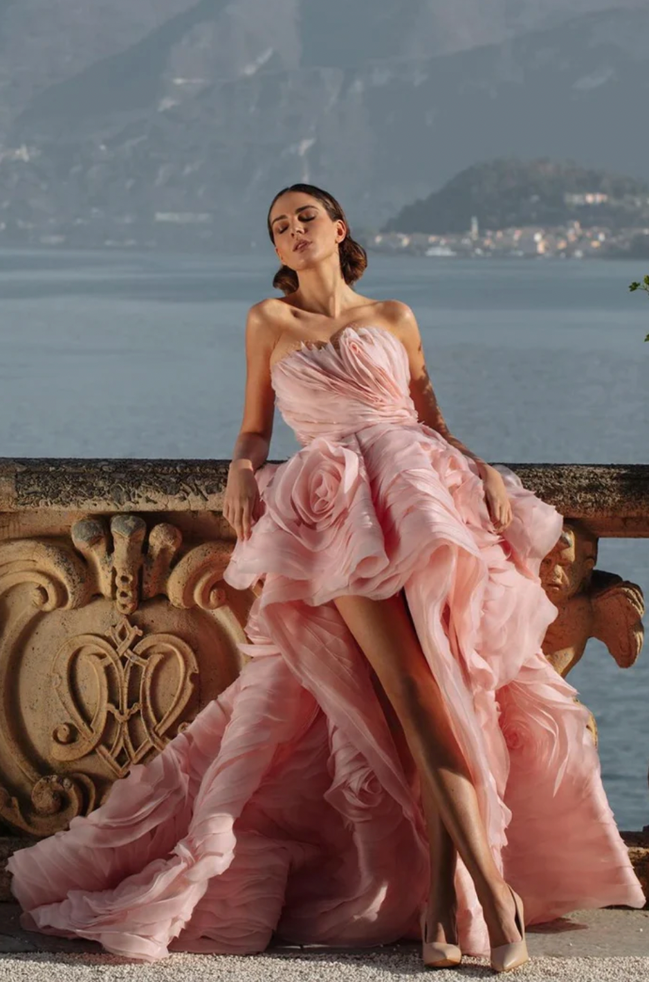 Indulge in luxury with the Rosalind Gown. This exquisite gown boasts a strapless design, adorned with delicate ruffles and rose-like embellishments. Made for the distinguished, the Rosalind Gown exudes elegance and grace. Make a statement at your next event and feel like a true work of art in this stunning gown.