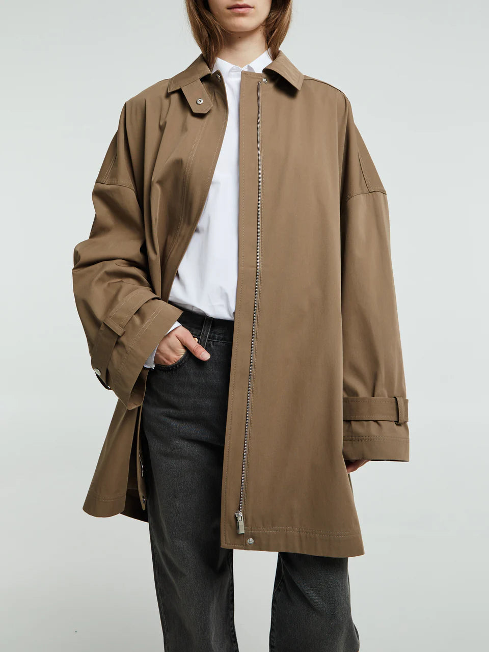 Elevate your everyday wardrobe with this timeless oversized trench jacket by Toteme in a sophisticated hazel tone. Crafted from a breathable cotton blend, it delivers effortless comfort without sacrificing style. The relaxed silhouette provides freedom of movement, making it perfect for layering through seasons. Whether you're dressing up or down, this minimalist essential transitions seamlessly from office to weekend, becoming the versatile piece you'll reach for again and again.