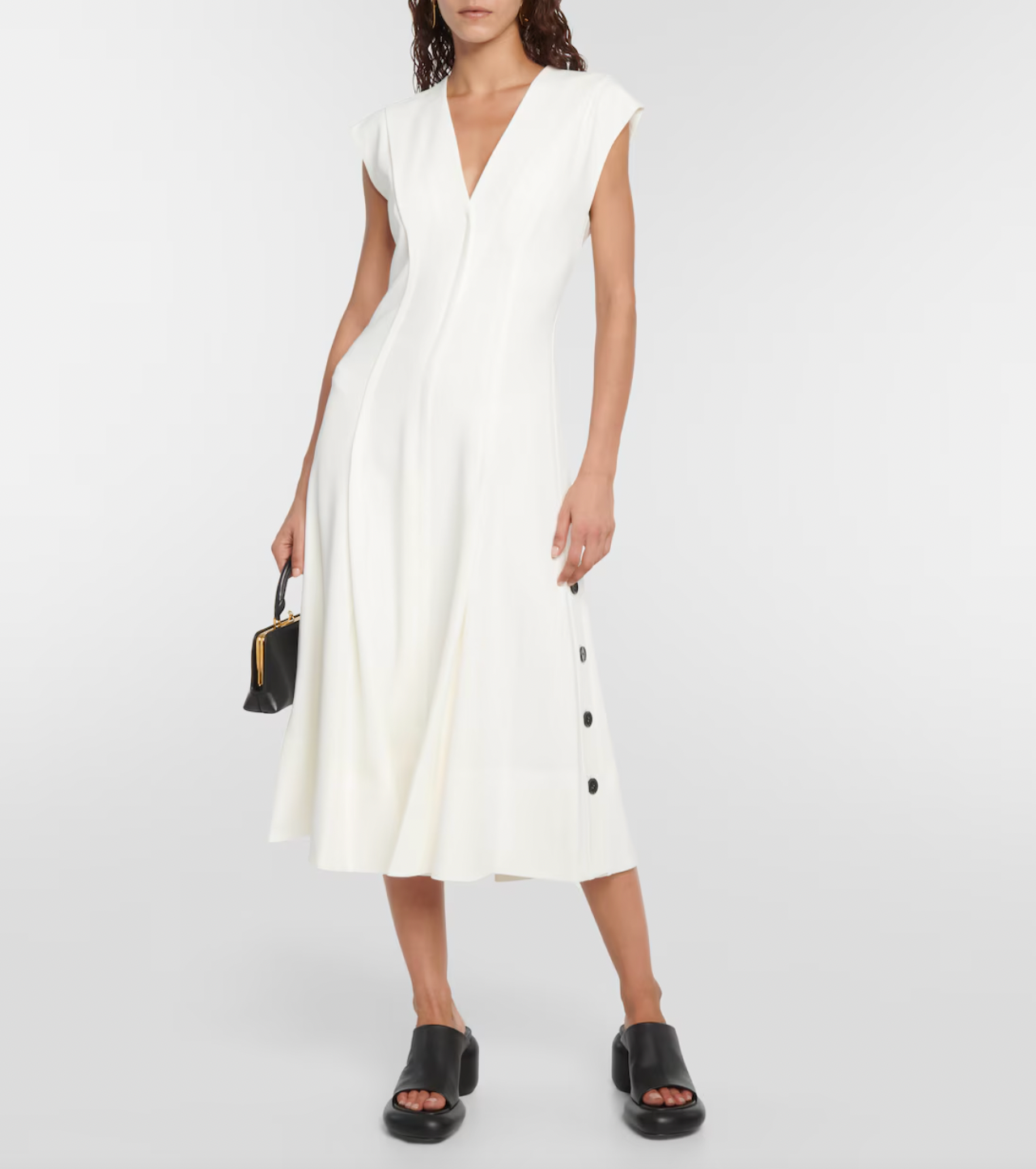 Elevate your wardrobe with this crepe midi dress, inspired by the timeless elegance of Proenza Schouler. Crafted from smooth crepe fabric, it boasts a flattering V-neckline and a fitted bodice that enhances your silhouette. The softly pleated A-line skirt adds gentle movement and grace, making it perfect for both special occasions and refined everyday wear. This dress combines effortless style with sophisticated charm, becoming an essential piece in any chic closet.