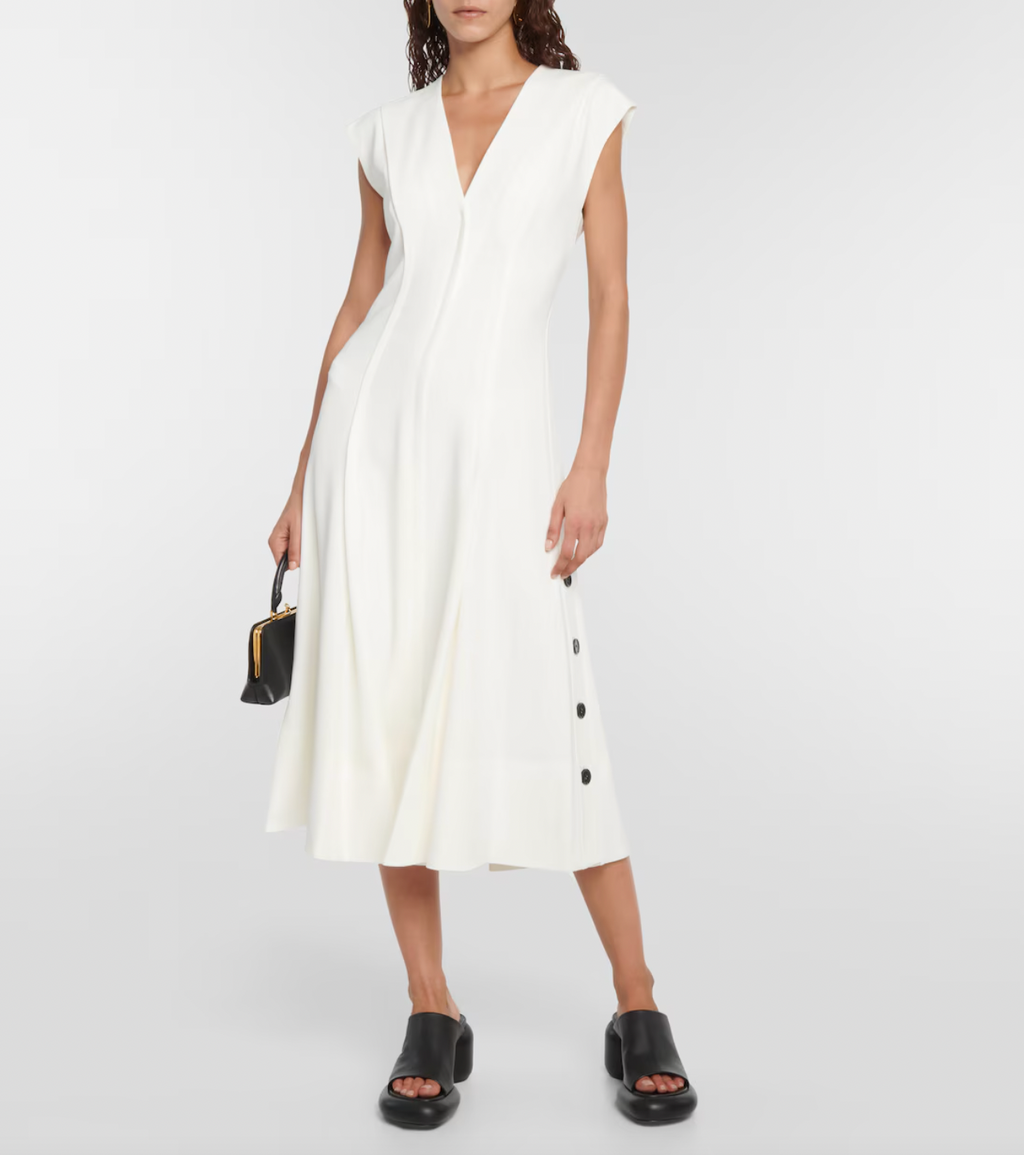 Elevate your wardrobe with this crepe midi dress, inspired by the timeless elegance of Proenza Schouler. Crafted from smooth crepe fabric, it boasts a flattering V-neckline and a fitted bodice that enhances your silhouette. The softly pleated A-line skirt adds gentle movement and grace, making it perfect for both special occasions and refined everyday wear. This dress combines effortless style with sophisticated charm, becoming an essential piece in any chic closet.