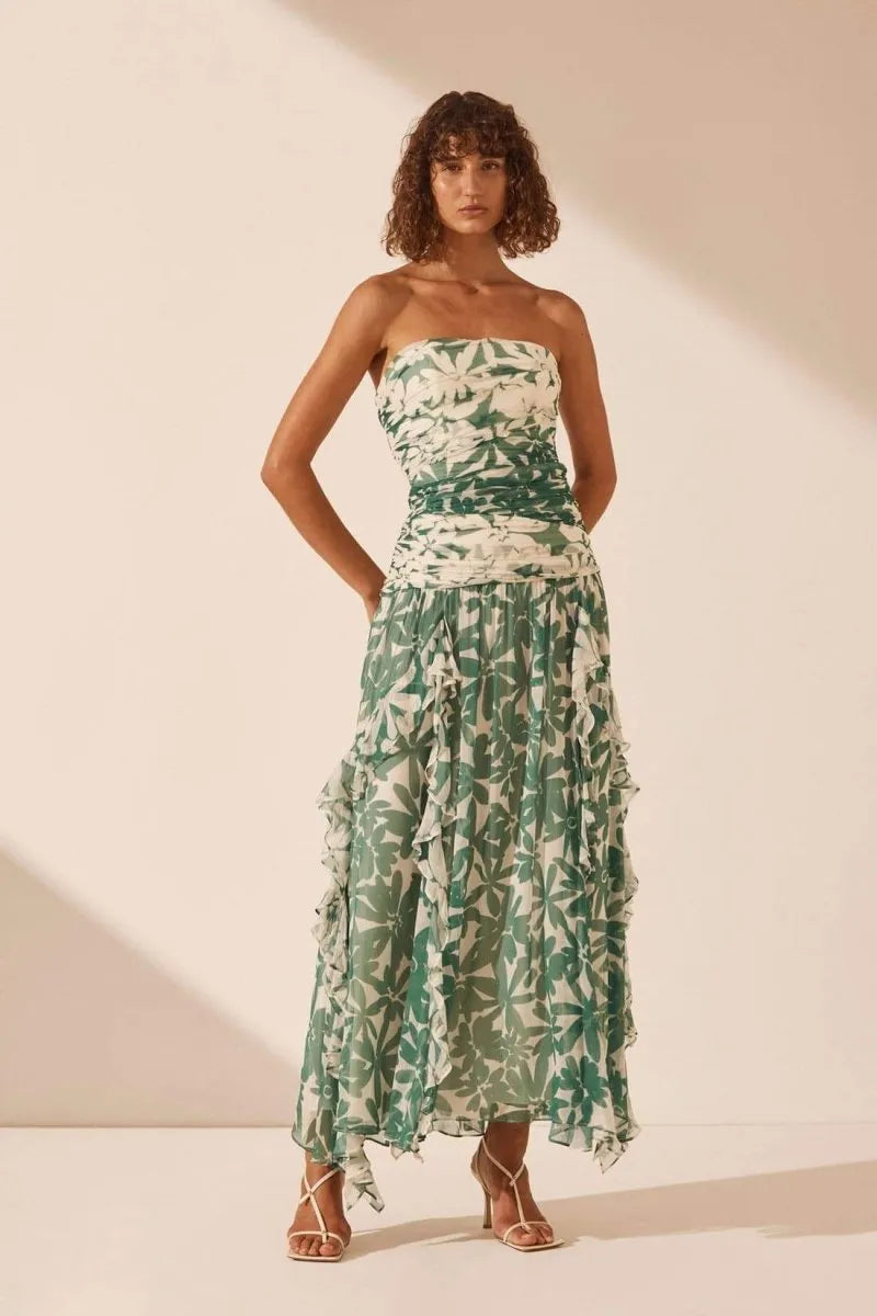 Unleash your inner flower child with the Marguerite Dress by Shona Joy! This stunning ruched maxi dress features a detachable strapless neckline and spliced contrast print, highlighting the exclusive Marguerite print. The lightweight semi-sheer chiffon adds a touch of elegance, while the boning in the bodice and invisible back zip provide a flattering fit. Perfect for any occasion, the gathered frill maxi length skirt will make you feel like a goddess.