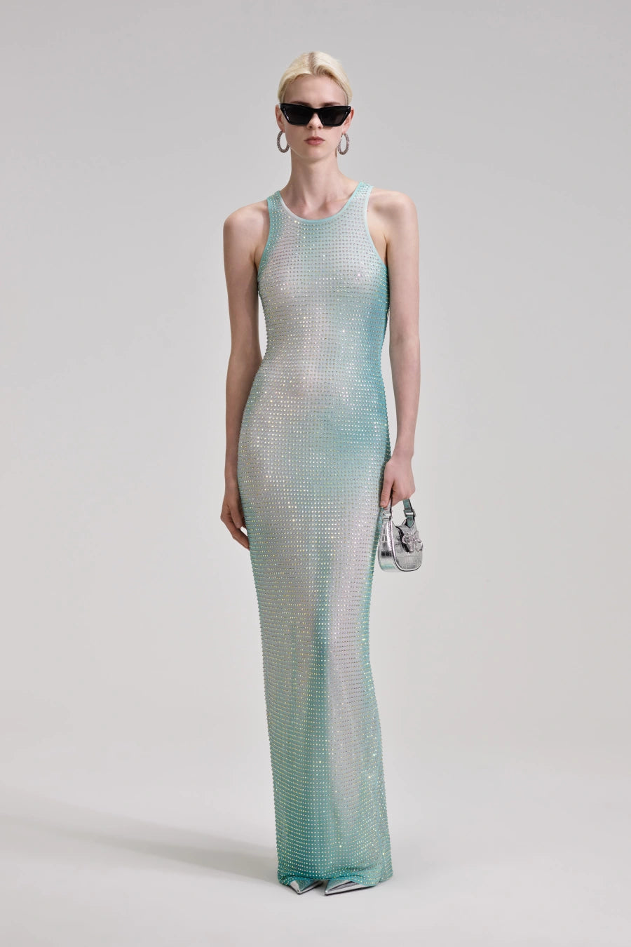 Experience pure opulence in the Green Contour Print Maxi Dress by Self Portrait. This shimmering dress features delicate crystals on gradient mesh, creating a mesmerizing effect that will turn heads. Elevate your style and make a statement with this luxurious and exclusive piece.