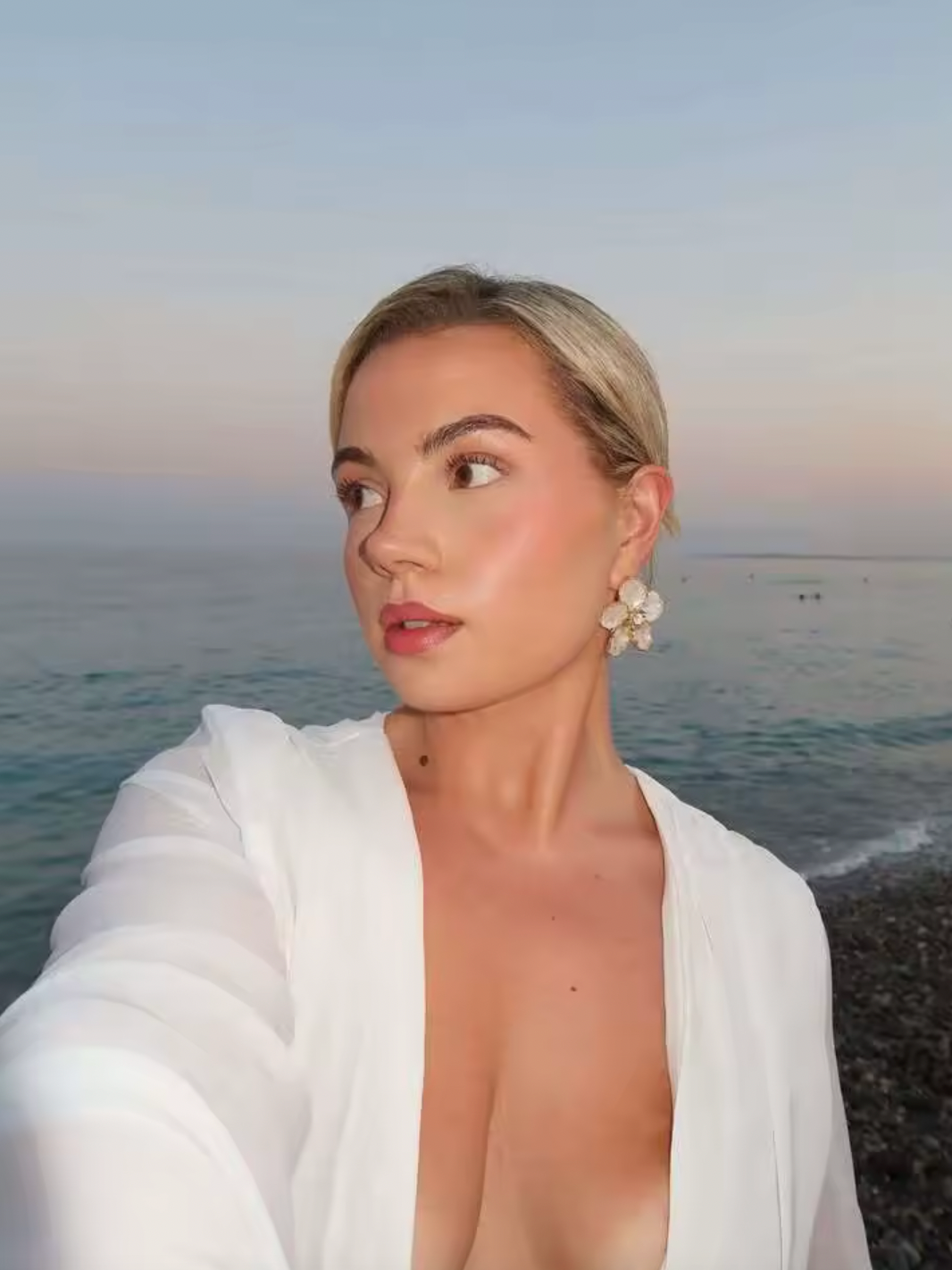 The Andrina Maxi Dress is a stunning statement piece that combines romance with modern elegance. Crafted from delicate chiffon, this maxi features long, sheer blouson sleeves and a daring deep plunge neckline that exudes confidence. The open lace-up back with adjustable ties allows you to customize your fit while showcasing an alluring silhouette. 