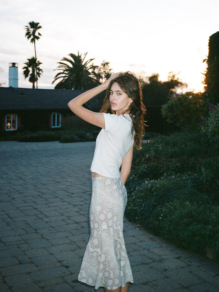 Experience the flirty and feminine charm of The Carmen in Absinthe by Realisation Par. This modern skirt features a flattering silhouette and fluted hemline that adds movement to every step. Perfect for any occasion, pair it with a fitted knit or crisp white tee for a versatile and effortless look. Indulge in classic charm with a touch of modern sophistication.