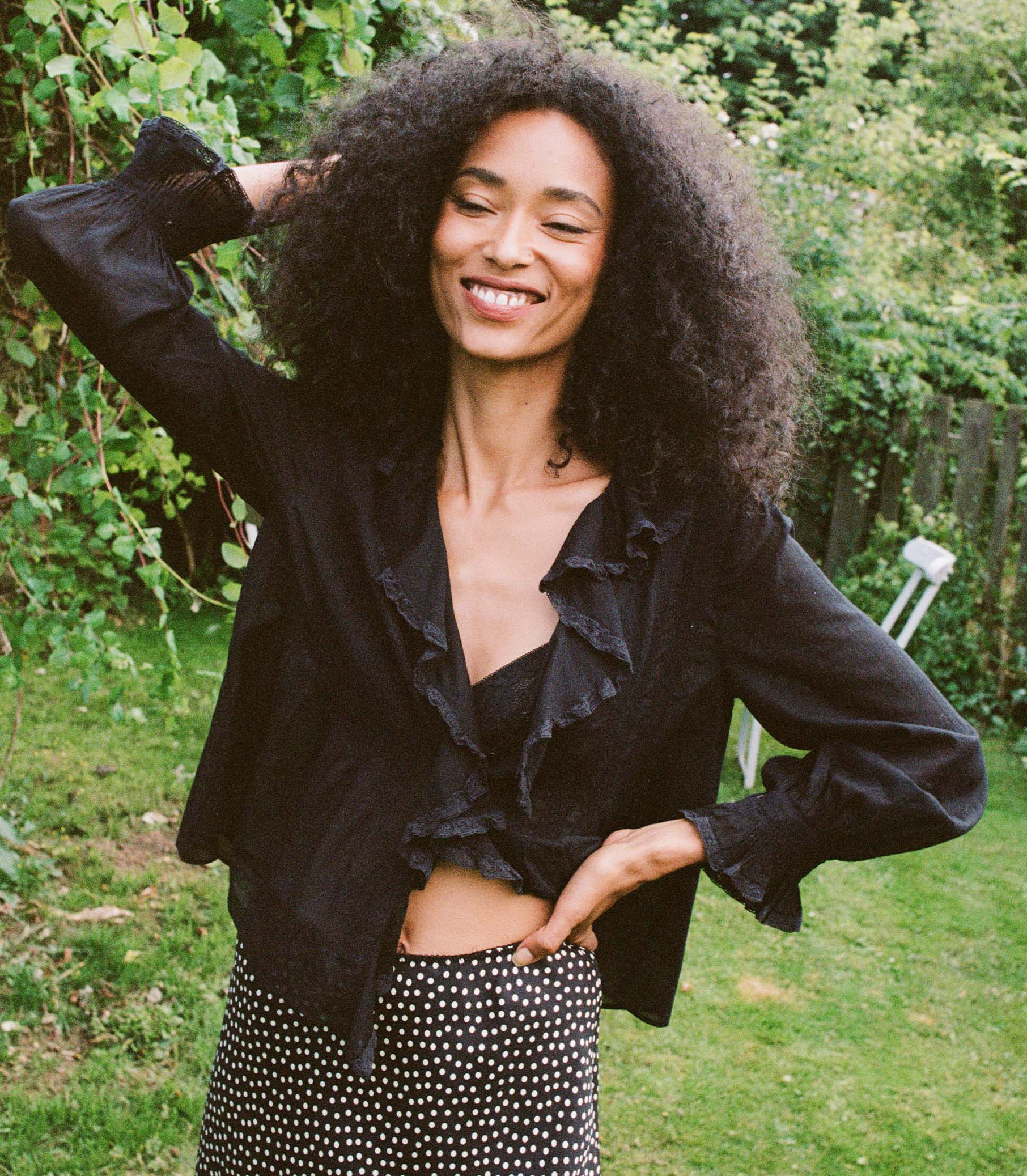 Introducing the Hardy Top in Black by Doen, an effortlessly elegant blouse that exudes French girl charm. With full sleeves, a delicate ruffle, and mother of pearl buttons, this blouse radiates sophistication. Crafted in 1970s-inspired pintucked design, it's perfect for any occasion - from casual outings to refined looks. Elevate your style with this versatile and comfortable blouse.