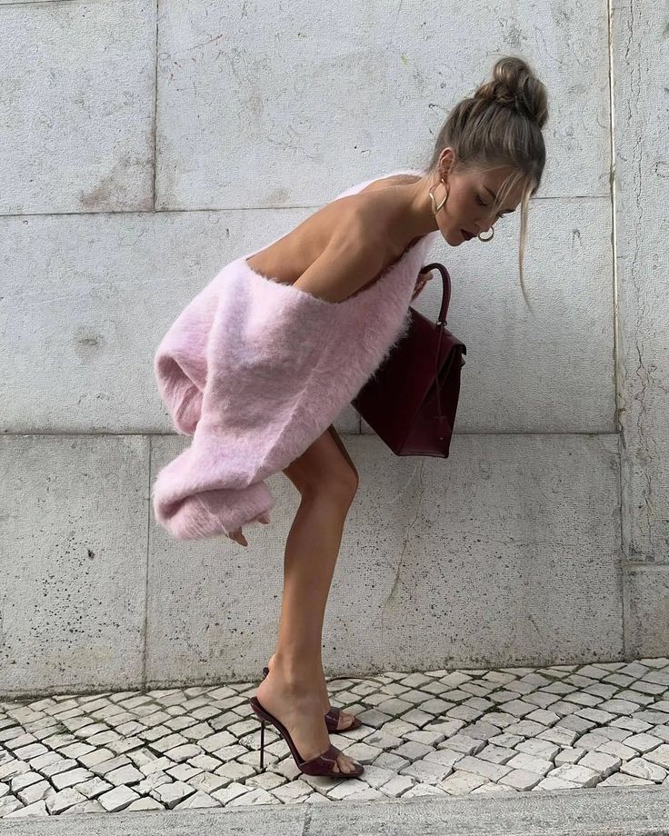 The Gemini Sweater Dress is not just another sweater dress. It's a statement piece that combines comfort and style. Made of a soft and fluffy material, it features a deep V-neck in the back for a touch of allure. Its loose fit adds a relaxed yet elegant touch to any outfit.